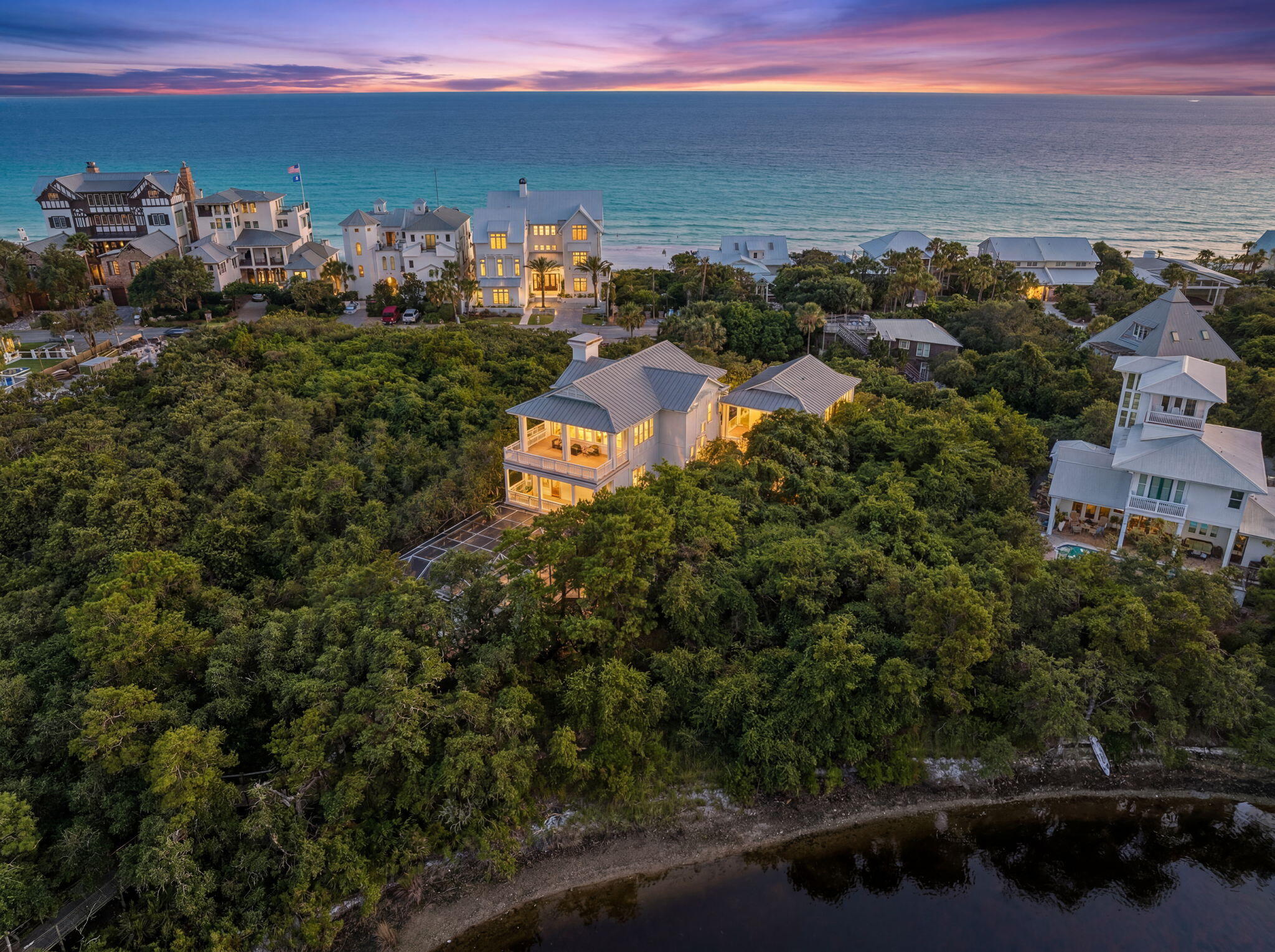 Designed with entertaining in mind, this lakefront residence in Blue Mountain Beach sits on Big Redfish Lake, one of the world's rare coastal dune lakes, offering peaceful lakefront living with the Gulf just across the street. Spanning approximately 5,276 square feet, the home features thoughtful design, high-end systems, and refined finishes throughout. The first floor offers 12-foot ceilings, recessed lighting, and a well-equipped kitchen ideal for hosting, complete with Sub-Zero appliances and a raised ventilation system over the stove. A custom pantry includes a dedicated juicing area with its own sink. A nearby half bath and elevator access to all levels add convenience.

The second floor is anchored by a private primary suite featuring Brazilian walnut flooring, a spa-like bathroom, a large walk-in closet with custom shelving, built-in sound wiring, and a kitchenette. A secondary guest bedroom, built-in bookcases, and an additional kitchenette with a microwave, sink, and beverage chillers provide flexible living options. A large patio with lake views connects directly to the carriage house, creating seamless indoor-outdoor flow.

The third floor is designed for entertaining, offering Brazilian walnut flooring, a gas fireplace, automatic window shades, ceiling speakers, a projector, theatre seating, two Sub-Zero wine coolers, a half bath, and a spacious lakefront patio. The elevator was serviced and inspected in 2025.

The gated outdoor space includes a pool with screened enclosure, irrigation system, direct lake access, and a private dock with power and water. The home is supported by three HVAC systems, including two geothermal units, one newly installed in 2025, along with a conventional system added in 2023.

The 812-square-foot carriage house offers a private bedroom with two closets, a full bath with walk-in shower, and a dedicated laundry room, ideal for guests or extended stays.

Located with easy access to the Timpoochee Trail for biking and walking, this home offers proximity to everything Scenic 30A has to offer. Sugar-white sands, emerald Gulf waters, fine dining, beloved local dives, and favorites like Blue Mountain Beach Creamery are all just moments away, delivering a rare combination of coastal dune lake living, Gulf convenience, and elevated design in the heart of Blue Mountain Beach. Contact us for more information or a private showing.



All information is deemed reliable and provided for informational purposes; buyers are encouraged to independently verify all details.