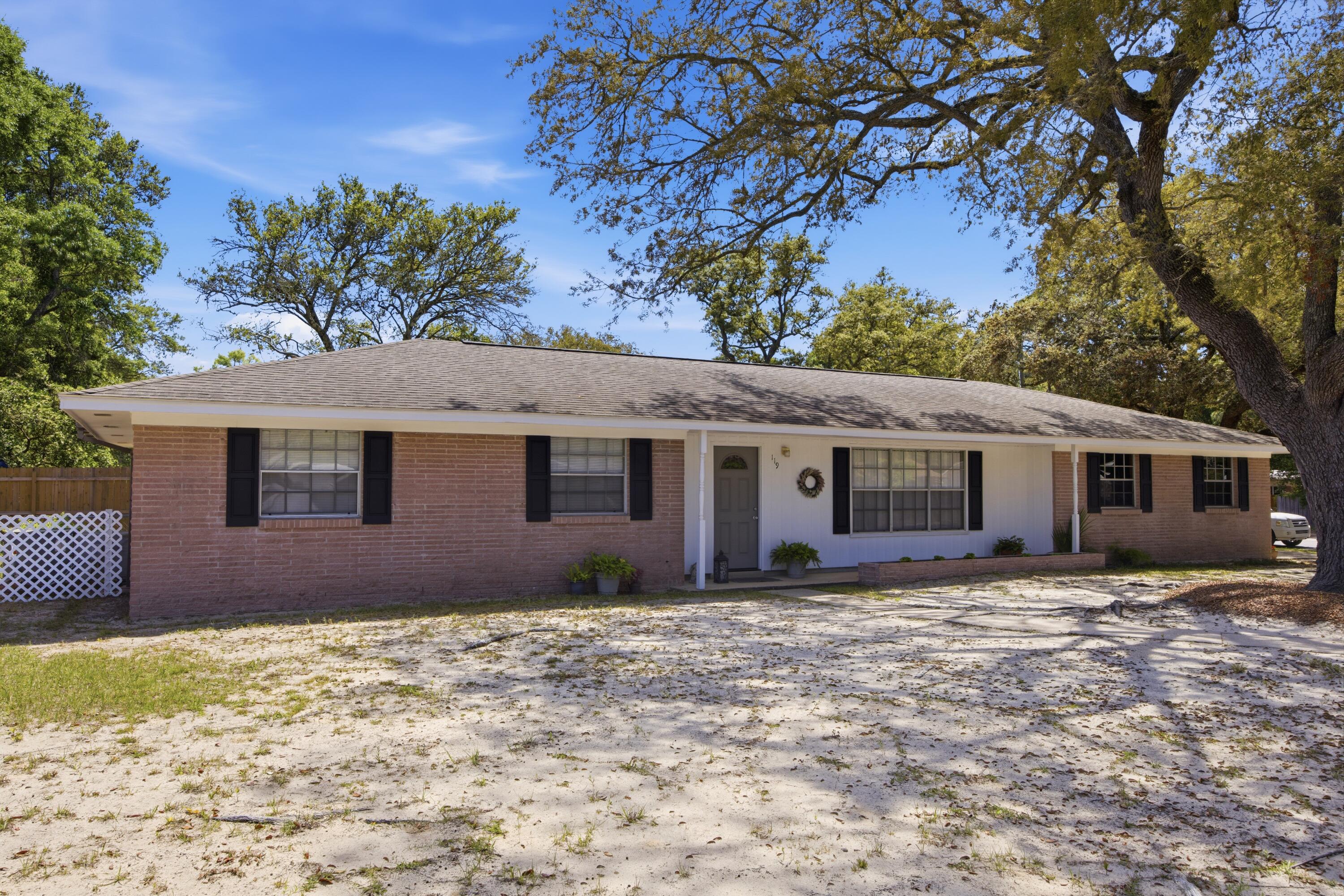 Perfect for buyers seeking both convenience and peace of mind, this well-maintained home at 119 Jamestown Ave offers a prime central location in Fort Walton Beach, just minutes from Hurlburt Field, Eglin AFB, beautiful Gulf Coast beaches, and highly rated zoned schools. Inside, you'll find a home that has been thoughtfully cared for with numerous system upgrades already completed for you. The HVAC system (2019) and has been consistently maintained, including recent updates to key components in 2022, 2024, and 2025, along with professional duct cleaning. Major plumbing improvements include a new hot water heater (2023), updated fixtures throughout, resurfaced bathtub, and a full replacement of the main water line with durable PEX piping, plus a newly installed water pressure regulator. Electrical updates include a replaced panel (2019) and routine system checks, offering added confidence in the home's infrastructure. Additional interior touches such as updated toilets, a modern kitchen faucet, and a new bedroom ceiling fan enhance everyday comfort, while exterior upgrades including a new front door, automatic garage door opener, full window screen replacement, and an irrigation system with lawn pump, add both function and curb appeal. The 2-car garage offers a workshop-style setup with built-in benches and shelving ready for your next project.  Mature live oak trees have also been professionally pruned, enhancing the beauty of the property. Whether you're commuting to base, heading to the beach, or enjoying the nearby schools and amenities, this home delivers an ideal blend of location, upgrades, and livability.