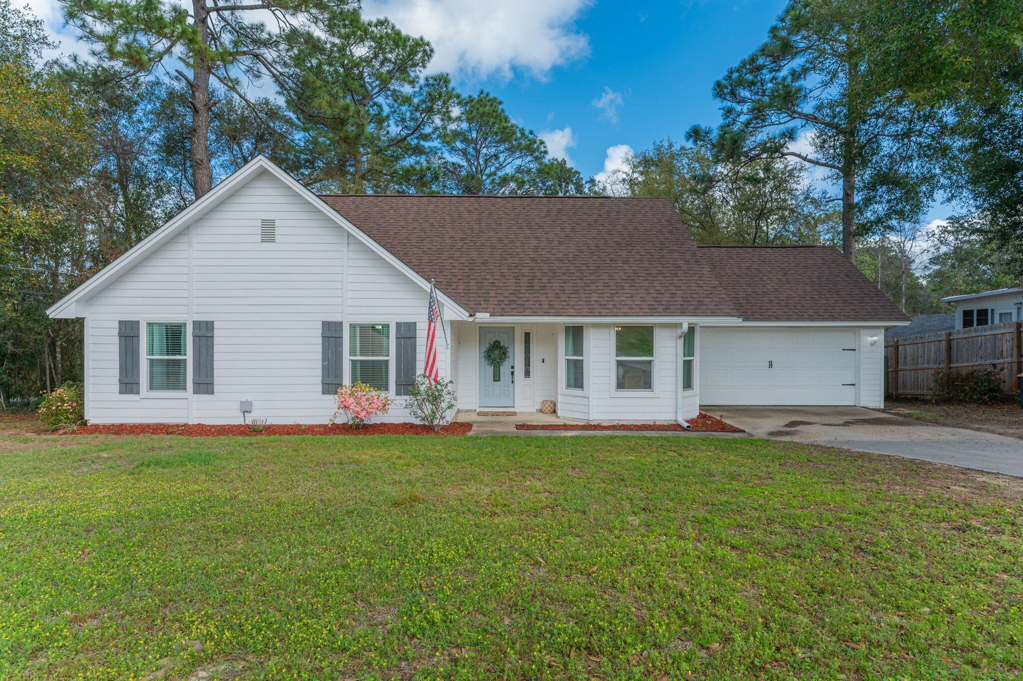 Welcome to this beautifully refreshed retreat in South Crestview, ideally situated on a generous corner lot with a peaceful, wooded backdrop. This home seamlessly blends style, comfort, and everyday functionality, all in a highly convenient location--just a short commute to Eglin Air Force Base (about 24 minutes) and Duke Field (approximately 12 minutes), making it an excellent choice for military families.

Inside, you'll find a thoughtfully designed layout that balances openness with cozy living. A striking staircase leads to a bright second-floor loft, perfect for a home office, creative space, or playroom. The primary suite serves as a private retreat, featuring direct access to an expansive 24-foot rear deck--an ideal spot to enjoy morning coffee or unwind in the evenings.  Inside, the spacious open living area flows seamlessly to the outdoors, creating an ideal setting for entertaining--whether you're gathering with guests inside or enjoying the privacy of the expansive backyard.