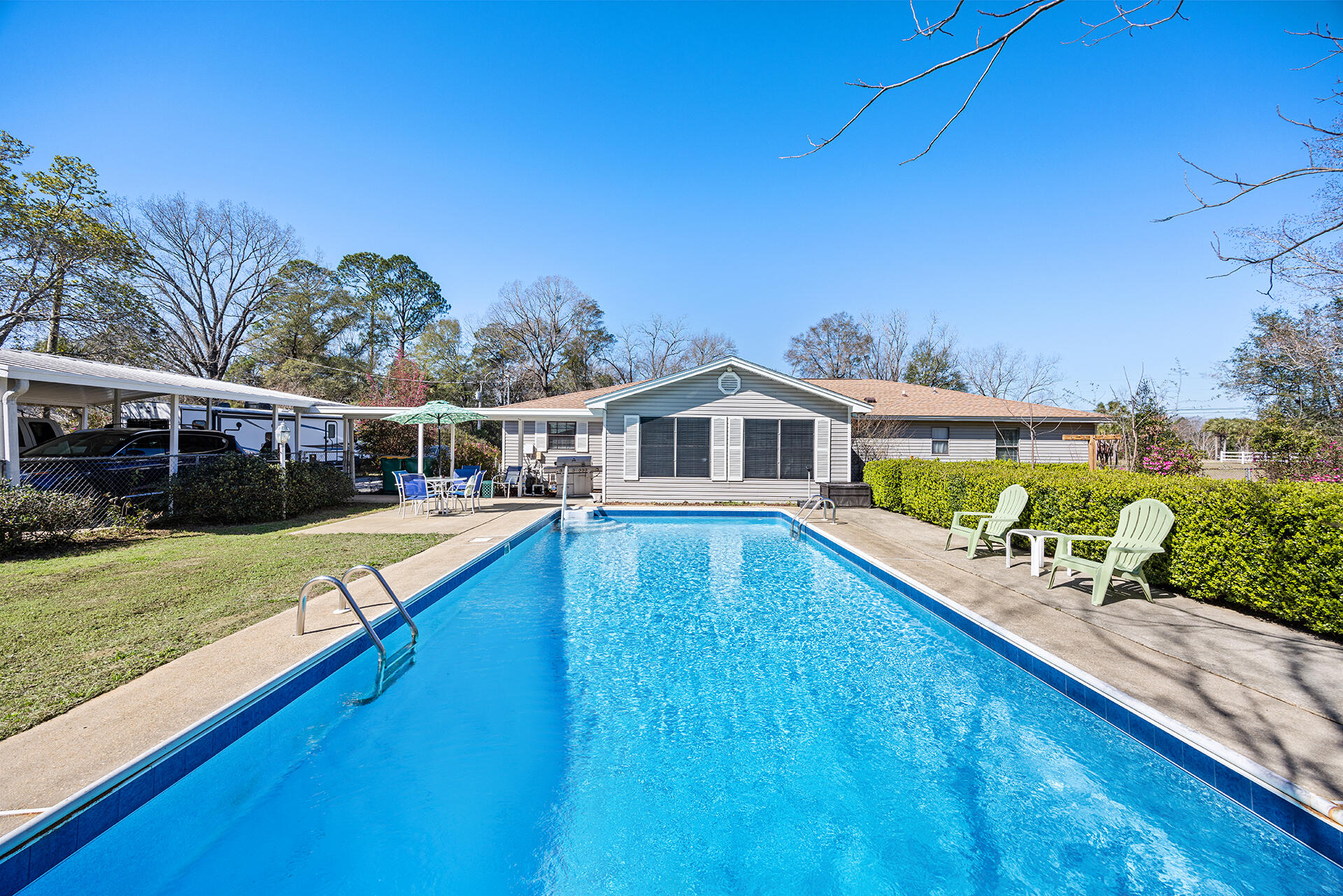 This rural property, set on a spacious 1-acre lot just off Airport Road, offers the perfect blend of convenience and charm, mere minutes from everything Crestview has to offer. Originally built in 1980. With a thoughtful split-bedroom layout, the home features not one, but two master suites, each with its own private bath--a rare and desirable feature. Spanning 2226 square feet, the house boasts laminate and tile flooring throughout, ensuring durability and style. The open-concept living room flows seamlessly into the kitchen, creating a warm and welcoming space for everyday living or entertaining. Plus, a separate family area overlooks the sparkling in-ground pool, offering the perfect setting for gatherings or simply relaxing. The office or possibly 4th bedroom on the north west corning shins with natural lite.The exterior is as impressive as the interior, with worry-free vinyl siding, 2024 composition shingle roof, a fully fenced backyard for added privacy, a carport for convenient parking, and a detached storage shed/workshop to meet all your needs. Bring your trailer, Fifth wheel or Motorhome.  Did we mention the newly lines inground pool with tile border. This is truly a must-see home--schedule your visit today before it's gone!