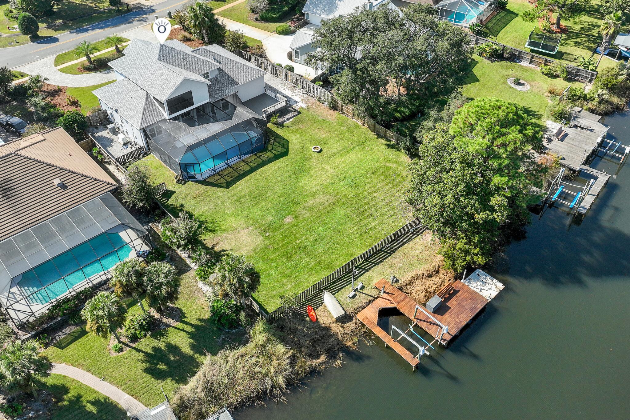 One of the most compelling waterfront values on deep water in all of Destin, and it shows zero signs of compromise. Tucked inside the beloved Indian Bayou neighborhood, this 5-bedroom, 3.5-bath beauty delivers 3,100 square feet of coastal living with a saltwater pool, private dock, and genuine deep-water access, all at a price point that stands out in today's Destin market.
The layout is made for real life. An open kitchen with granite countertops flows into the living and dining areas, so the conversation never stops when you come in from the water. The owner's suite overlooks the bayou for peaceful wake-ups every morning. Two side-by-side guest rooms on the main level can easily function as a secondary primary suite, great for multigenerational families or guests who want their own space. A bonus room adds flexibility for a home office, media room, or bunk room.
Outside is where this home earns its price. A saltwater pool with a new liner, covered patio, and a private dock with boat slip sitting on deep water. You're 15 minutes from the Gulf through East Pass, with Crab Island, Destin Harbor, and world-class fishing right from your backyard. The oversized garage fits an RV, a rare find anywhere on the Emerald Coast. The location is the kind buyers don't find twice. Golf cart to the beach. Minutes to HarborWalk Village, Destin Commons, championship golf, and every restaurant and shop the Destin lifestyle has to offer. Indian Bayou means low HOA fees, an established welcoming community, and a neighborhood feel that's hard to replicate at any price.

This is the waterfront Destin dream at exceptional value. Come see it before someone else does.