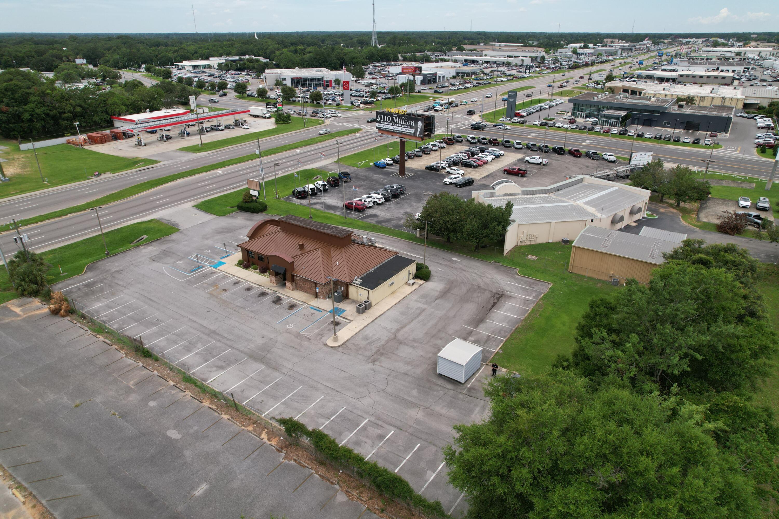 Highly visible commercial property located directly on Pensacola Blvd, offering strong daily traffic exposure and excellent frontage. The space provides a flexible layout suitable for retail, office, or service-based users, with ample parking and easy access for customers and deliveries. Positioned along a major commercial corridor surrounded by national retailers and established businesses, this location is ideal for companies seeking visibility and consistent drive-by traffic.