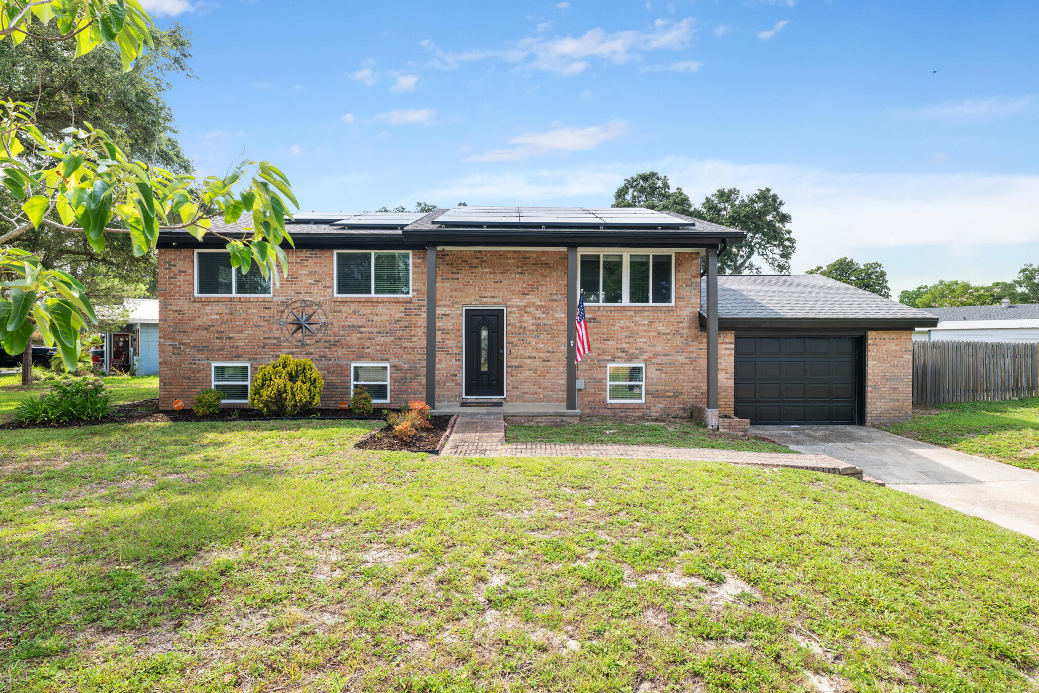Welcome to 102 NW Robinwood Drive, a beautifully updated 5-bedroom, 2.5-bath brick home in Fort Walton Beach's established Bel Air neighborhood. Situated on a fully fenced corner lot, this move-in-ready home combines timeless character with extensive modern updates and a location that puts you just minutes from shopping, dining, schools, Eglin Air Force Base, Hurlburt Field, and the Emerald Coast's world-famous beaches.

Inside, you'll find fresh interior paint, updated lighting and fixtures, new carpet in the secondary bedrooms, and stylish new flooring in the kitchen. The thoughtfully designed kitchen features granite countertops with striking amber veining, dark cabinetry accented by a glass tile backsplash, stainless steel appliances, and a gas range, creating a functional and inviting space for everyday living and entertaining.

The spacious primary suite offers a peaceful retreat with private access to the backyard, a walk-in closet, dual vanities, and a beautifully tiled walk-in shower. Four additional bedrooms provide flexibility for family, guests, or a home office.

Step outside to enjoy the private backyard featuring an open deck, raised garden beds, a dedicated fire pit area, and plenty of room to relax or entertain. The oversized one-car garage provides additional storage and workspace.

Major improvements provide peace of mind, including a new roof (2020), energy-efficient windows (2019), HVAC system (2019), and water heater (2018) updated electric (2021).