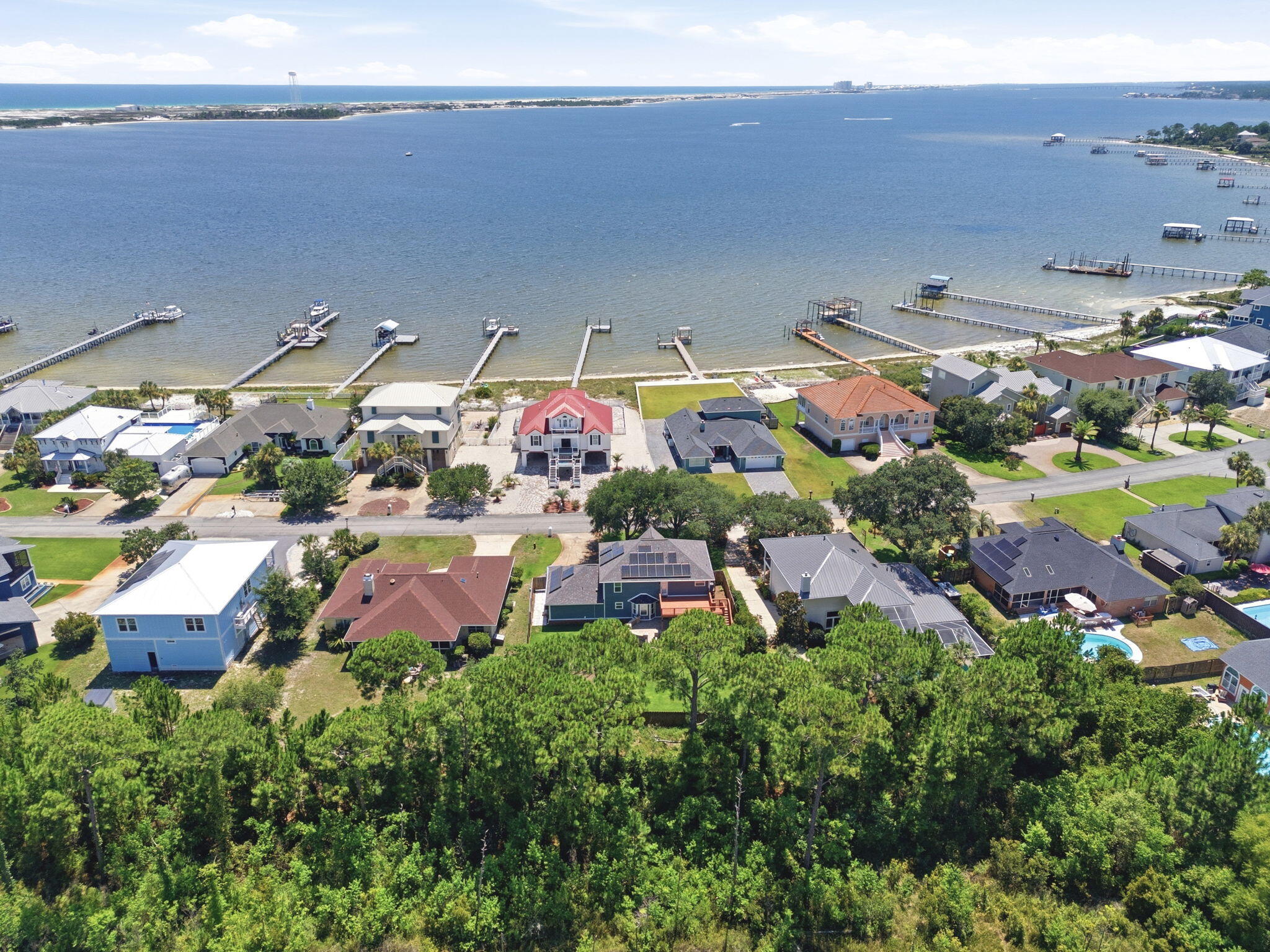 Emerald Pointe | Coastal Luxury Reimagined

Welcome to Emerald Pointe, one of the Emerald Coast's most desirable waterfront communities, where coastal living meets everyday convenience. Known for its abundance of water-view homes, neighborhood beach access, and breathtaking views of the Santa Rosa Sound, this community offers the lifestyle so many dream about.

Completely reimagined from the inside out, this stunning two-story coastal blue beauty has been professionally remodeled and reconfigured to rival brand-new construction. Every detail was thoughtfully designed with quality, longevity, and modern coastal elegance in mind.

From the moment you arrive, you'll appreciate the meticulous landscaping, oversized backyard entertaining deck, corner storage shed, and fully fenced backyard with plenty of room to build the pool you've always wanted. Many neighboring homes already feature private pools, making this an ideal backyard retreat.

Step inside and you'll immediately notice the abundance of natural light pouring through the dramatic staircase windows while beautiful water views greet you from multiple rooms throughout the home. Step outside into the front yard and you'll even hear the relaxing sound of the nearby waves. The extensive renovation includes impact-rated windows throughout, new Hardie® siding, gutters, modern driftwood-inspired luxury vinyl plank flooring, new cabinetry, premium appliances, a gas range, tankless gas water heater, new PEX plumbing, upgraded electrical, designer lighting, modern ceiling fans, updated hardware, and beautifully redesigned bathrooms. Custom closet systems replace traditional wire shelving throughout much of the home, offering both style and functionality.

Designed for today's lifestyle, this spacious floor plan offers 4 bedrooms, an oversized family room overlooking the breakfast area and designer kitchen, an expansive walk-in laundry room, dedicated office, plus an additional flex room with water views--perfect for a second office, homeschool space, children's playroom, reading nook, or fitness area.

One of the greatest advantages of this home is the peace of mind that comes with such an extensive renovation. During ownership, the sellers discovered evidence of prior termite damage from years before they purchased the property. Rather than simply making cosmetic repairs, they made the decision to professionally rebuild the affected areas correctly using licensed contractors and high-quality materials throughout. The result is a home that offers the character of an established neighborhood with the confidence and quality of modern construction.

Living in Emerald Point means enjoying kayaking, paddleboarding, fishing, and waterfront sunsets just steps from your neighborhood--without battling Highway 98 traffic to reach the water. The community offers spectacular views of the Navarre Bridge and surrounding waterfront while remaining only one minute from East Navarre, less than 10 minutes to Navarre Beach, and under 30 minutes to Destin. Hurlburt Field, Eglin AFB, schools, shopping, restaurants, and grocery stores are all conveniently nearby, making this location ideal for both military and civilian buyers.

With nearly every major system upgraded, buyers may also benefit from more favorable insurance opportunities compared to homes with older components. Combined with the move-in-ready condition, professional cleaning, and immediate availability for closing, this is an exceptional opportunity to own a beautifully renovated coastal home in one of the area's most sought-after waterfront communities.

If you've been searching for water views, quality craftsmanship, and a home that truly feels like new construction--without the new construction price tag--this Emerald Pointe masterpiece is one you simply cannot miss.