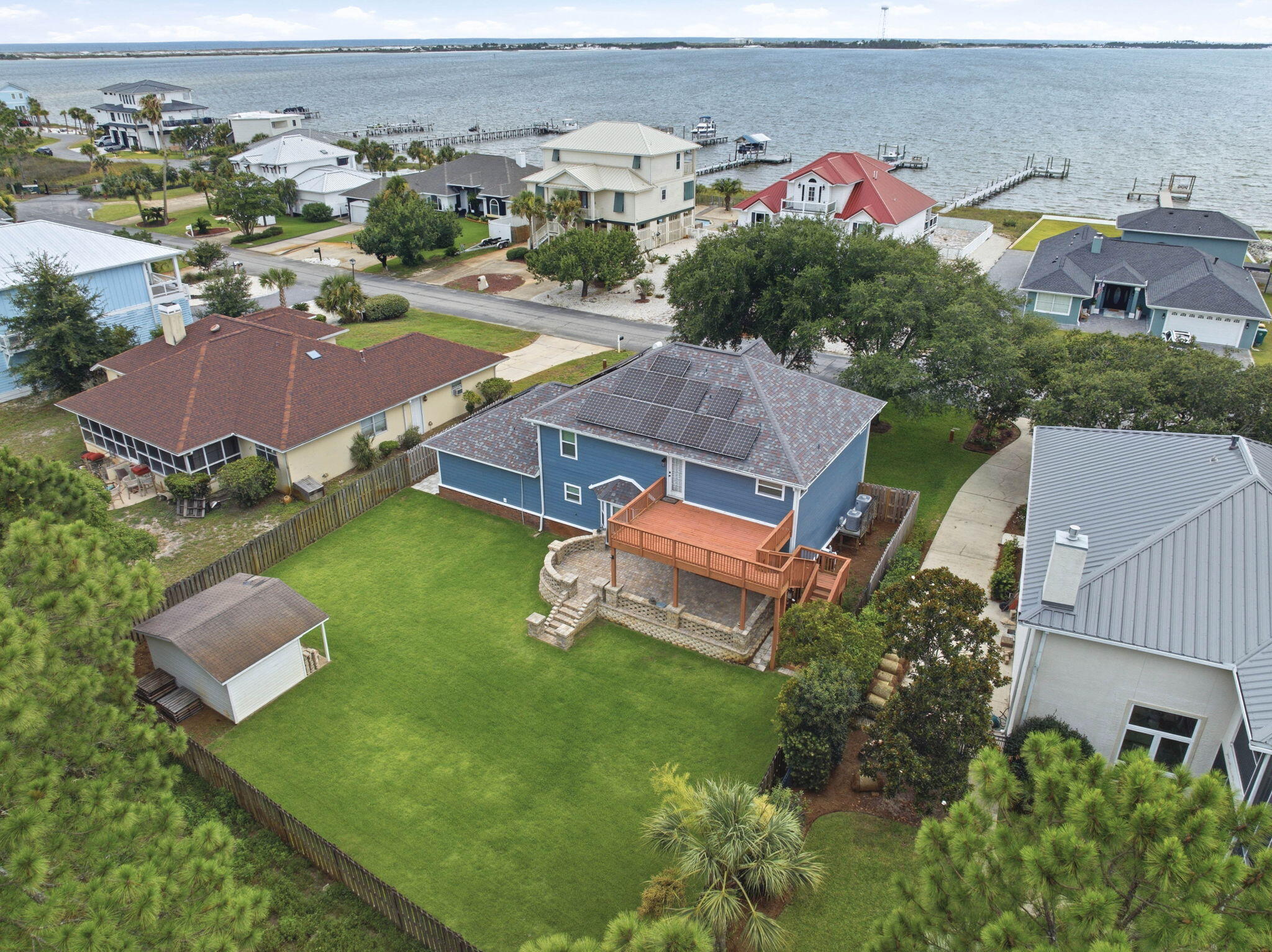 Emerald Pointe | Coastal Luxury Reimagined

Welcome to Emerald Pointe, one of the Emerald Coast's most desirable waterfront communities, where coastal living meets everyday convenience. Known for its abundance of water-view homes, neighborhood beach access, and breathtaking views of the Santa Rosa Sound, this community offers the lifestyle so many dream about.

Completely reimagined from the inside out, this stunning two-story coastal blue beauty has been professionally remodeled and reconfigured to rival brand-new construction. Every detail was thoughtfully designed with quality, longevity, and modern coastal elegance in mind.

From the moment you arrive, you'll appreciate the meticulous landscaping, oversized backyard entertaining deck, corner storage shed, and fully fenced backyard with plenty of room to build the pool you've always wanted. Many neighboring homes already feature private pools, making this an ideal backyard retreat.

Step inside and you'll immediately notice the abundance of natural light pouring through the dramatic staircase windows while beautiful water views greet you from multiple rooms throughout the home. Step outside into the front yard and you'll even hear the relaxing sound of the nearby waves. The extensive renovation includes impact-rated windows throughout, new Hardie® siding, gutters, modern driftwood-inspired luxury vinyl plank flooring, new cabinetry, premium appliances, a gas range, tankless gas water heater, new PEX plumbing, upgraded electrical, designer lighting, modern ceiling fans, updated hardware, and beautifully redesigned bathrooms. Custom closet systems replace traditional wire shelving throughout much of the home, offering both style and functionality.

Designed for today's lifestyle, this spacious floor plan offers 4 bedrooms, an oversized family room overlooking the breakfast area and designer kitchen, an expansive walk-in laundry room, dedicated office, plus an additional flex room with water views--perfect for a second office, homeschool space, children's playroom, reading nook, or fitness area.

One of the greatest advantages of this home is the peace of mind that comes with such an extensive renovation. During ownership, the sellers discovered evidence of prior termite damage from years before they purchased the property. Rather than simply making cosmetic repairs, they made the decision to professionally rebuild the affected areas correctly using licensed contractors and high-quality materials throughout. The result is a home that offers the character of an established neighborhood with the confidence and quality of modern construction.

Living in Emerald Point means enjoying kayaking, paddleboarding, fishing, and waterfront sunsets just steps from your neighborhood--without battling Highway 98 traffic to reach the water. The community offers spectacular views of the Navarre Bridge and surrounding waterfront while remaining only one minute from East Navarre, less than 10 minutes to Navarre Beach, and under 30 minutes to Destin. Hurlburt Field, Eglin AFB, schools, shopping, restaurants, and grocery stores are all conveniently nearby, making this location ideal for both military and civilian buyers.

With nearly every major system upgraded, buyers may also benefit from more favorable insurance opportunities compared to homes with older components. Combined with the move-in-ready condition, professional cleaning, and immediate availability for closing, this is an exceptional opportunity to own a beautifully renovated coastal home in one of the area's most sought-after waterfront communities.

If you've been searching for water views, quality craftsmanship, and a home that truly feels like new construction--without the new construction price tag--this Emerald Pointe masterpiece is one you simply cannot miss.