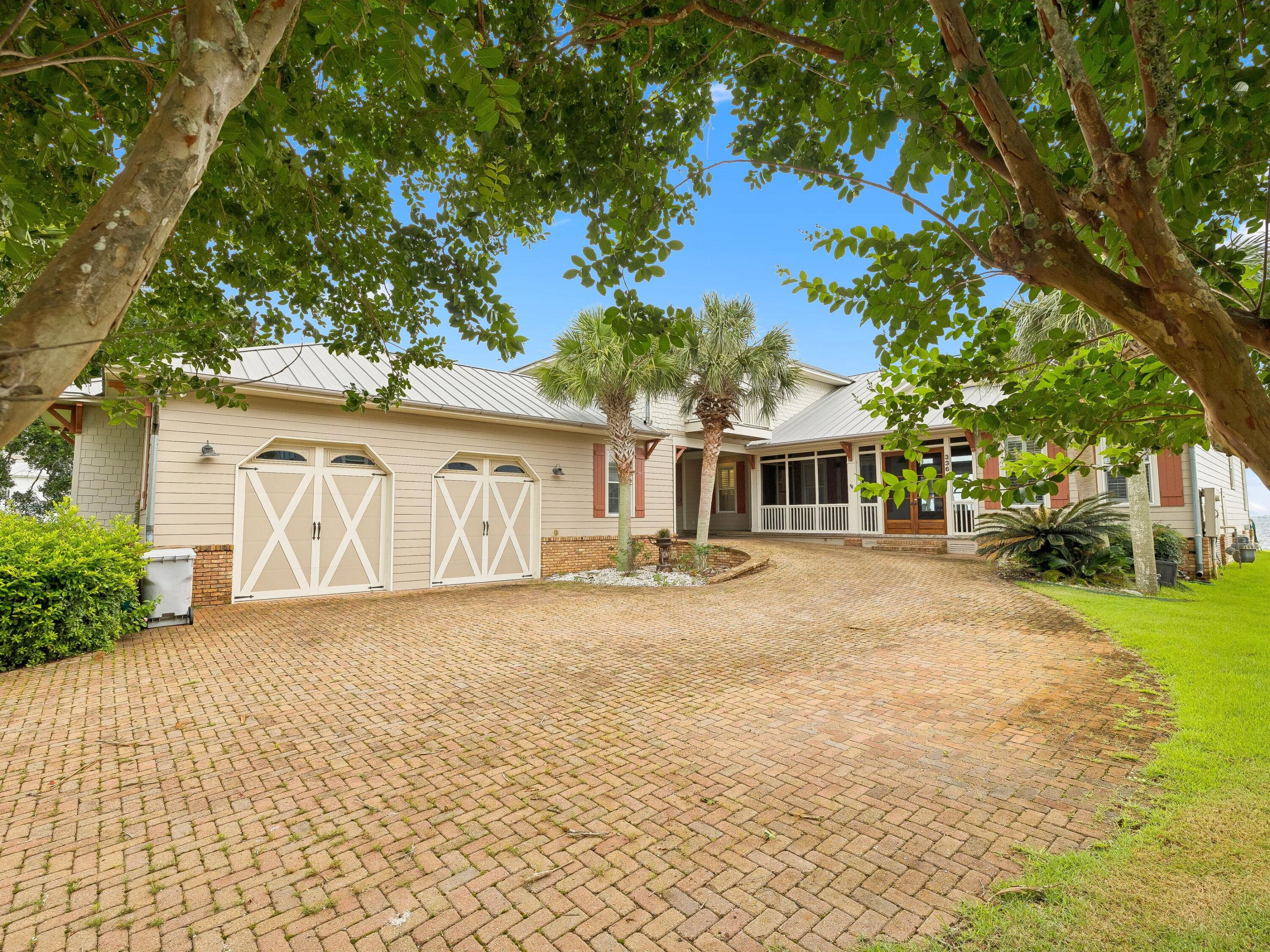 Positioned along the tranquil shores of the Santa Rosa Sound, this waterfront residence balances luxury, functionality and coastal living with remarkable ease. Thoughtfully designed for both entertaining and everyday comfort, the home features open indoor and outdoor living spaces, private boating access and panoramic water views throughout.

A welcoming screened foyer and custom entry doors open to soaring ceilings and an open-concept floor plan filled with natural light. Oversized sliding glass doors frame stunning views of the sound while seamlessly connecting the main living areas to the outdoor entertaining spaces beyond.

At the heart of the home, the well-appointed kitchen was designed to impress. Two oversized islands provide abundant prep and gathering space, including a dedicated entertaining station complete with a bar sink, beverage refrigerator and ice maker. Premium appliances include a Viking six-burner gas cooktop, double ovens, built-in microwave, Miele dishwasher with additional dishwasher drawer and an oversized built-in KitchenAid refrigerator. Extensive cabinetry, pull-out storage systems and a spacious pantry with additional workspace further enhance the kitchen's functionality.

The dining area and great room overlook the water and flow effortlessly onto the covered back porch, where a fireplace and outdoor kitchen create the ideal setting for year-round entertaining. Just steps away, a private dock with a boat lift extends into the sound, offering direct access for boating, fishing, paddleboarding and swimming.

The main-level primary suite serves as a private waterfront retreat with direct porch access and south-facing windows capturing picturesque water views. The spacious ensuite bath features dual vanities, two oversized walk-in closets, a whirlpool tub, an expansive walk-in shower with multiple shower heads. A second bedroom and full bath are also located on the main floor.

Upstairs, a loft-style landing opens to an additional living area, providing flexible space for relaxation or recreation. Two guest bedrooms with walk-in closets share a Jack-and-Jill bath, while a separate fifth bedroom and full bath located next to the garage offer additional privacy for visitors.

Additional features include an oversized two-car garage, covered parking area, riprap seawall and numerous custom finishes throughout. Combining quality construction, thoughtful design and an enviable soundfront setting, this exceptional property offers a rare opportunity to experience the best of waterfront living on the Emerald Coast.