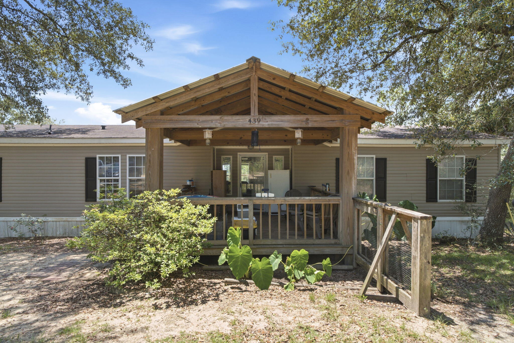 This charming private wooded property is awaiting its new owners. This house offers plenty of room for entertainment inside and out. The living room has a cozy wood-burning fireplace. And the kitchen is a must-see with plenty of storage. The spacious primary bedroom has an ensuite with a shower and separate garden tub with a view! The split floor plan offers 2 separate bedrooms and bathroom on the opposite side of the home. Step outside to a spacious, covered front deck, and  the back deck is  perfect for wildlife viewing.