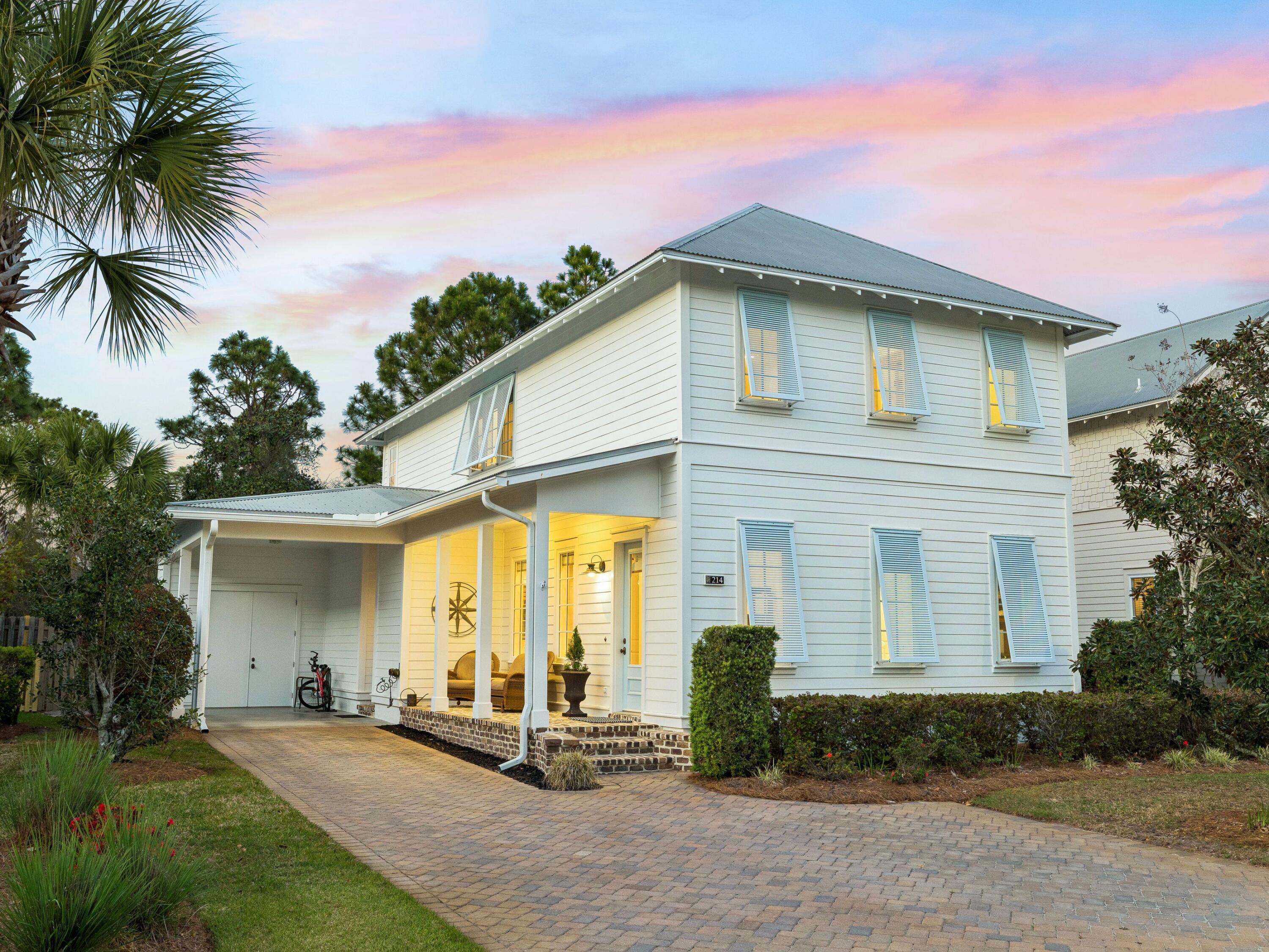 Tucked beneath a canopy of century-old live oaks, this beautifully appointed residence in the coveted Carson Oaks enclave embodies the timeless charm and relaxed sophistication of Florida cottage living. Built by Huff Development and thoughtfully enhanced, 214 Carson Oaks Lane offers an exceptional blend of refined finishes, modern updates, and a lifestyle defined by both tranquility and connection. Spanning approximately 2,438 square feet, the home features three bedrooms and three full baths, gracefully arranged across two levels. Upon arrival, a welcoming Charleston-style front porch sets the tone, inviting quiet mornings and evening gatherings. Inside, 10-foot ceilings and an open-concept living, dining, and kitchen area create an airy, elegant atmosphere ideal for both everyday living and entertaining. The kitchen is appointed with granite countertops, refreshed cabinetry (2026), and stainless steel appliances, seamlessly blending style and functionality. The main level has travertine flooring throughout and offers a private guest suite with a full bath. The living space extends effortlessly to a spacious screened-in porch, where lush landscaping and a fenced backyard create a serene outdoor retreat. Upstairs, the beautifully updated engineered wood plank flooring set the stage for the primary suite and an additional bedroom each feature ensuite baths, complemented by a generous secondary living area--perfect as a media room, office, or additional gathering space. Additional highlights include Hunter Douglas window treatments, a metal roof, new HVAC systems (2022), tankless/gas water heater (2018), exterior repainting, and a convenient carport with adjacent storage. Carson Oaks is a hidden gem along the Emerald Coast, offering residents exclusive access to a private deep-water boat launch on Mack Bayou with direct access to Choctawhatchee Bay, along with gated boat storage, a dock, and a waterfront pavilion complete with a fireplace and picnic areas. Community amenities also include a resort-style pool, pickleball court, and tranquil green spaces woven throughout the oak-lined neighborhood. Ideally located just minutes from Grand Boulevard, Sandestin, Sacred Heart Hospital, and the sugar-white beaches of South Walton, this residence presents a rare opportunity to enjoy refined coastal living in one of the area's most charming and well-appointed communities.