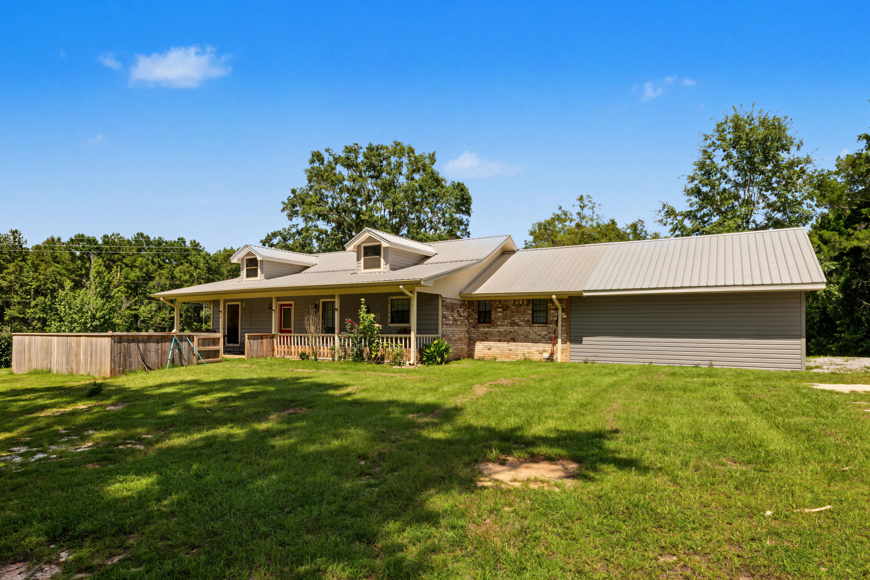 Welcome to country living at its finest! If you've been searching for the perfect blend of peaceful surroundings, usable land, and endless potential, this incredible property is ready to make your dreams a reality. Nestled on approximately 9 beautiful acres, this one-of-a-kind property offers the ideal setting for horse enthusiasts, hobby farmers, outdoor lovers, or anyone looking to enjoy the privacy and freedom that only country living can provide.

The true centerpiece of this property is the impressive 32' x 60' barn, complete with horse stalls and ample space for equipment, hay storage, or additional livestock. Whether you're an experienced equestrian or simply looking for room to grow, you'll appreciate the functionality and versatility this barn provides. In addition, the property features a detached garage/workshop with an attached covered carport, making it perfect for mechanics, woodworkers, small business owners, or anyone needing extra storage for vehicles, boats, tractors, or recreational equipment.

The home offers a comfortable 3-bedroom, 2-bath split floor plan designed with both privacy and functionality in mind. While the interior could benefit from cosmetic updates, it provides an excellent opportunity to personalize the home and build equity while creating the country retreat you've always envisioned. The spacious family room is perfect for those gathering with family and friends with an access to the oversized back porch. A must see!!!
