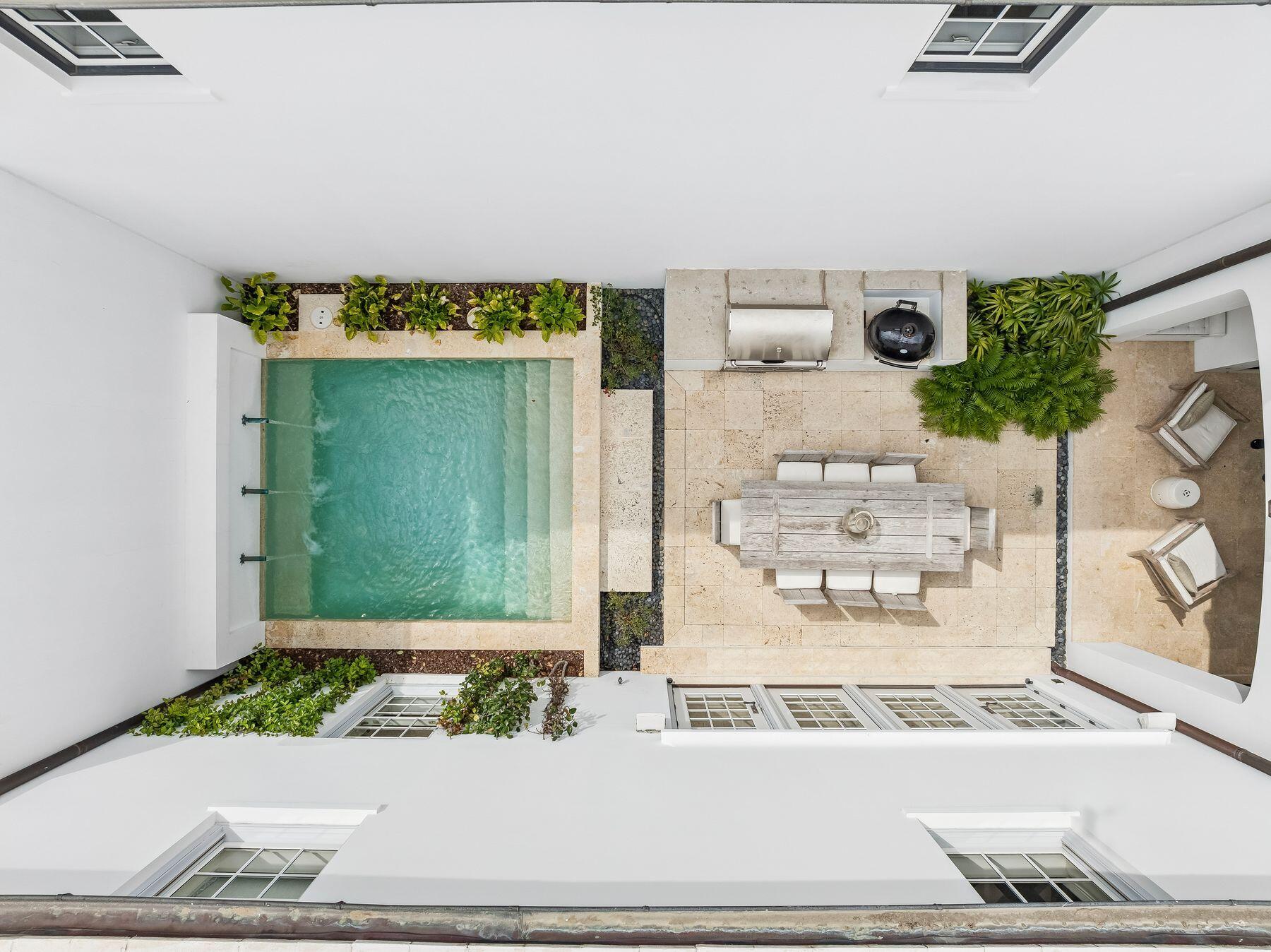 An extraordinary Gary Justiss-designed residence in the heart of Alys Beach is now available, offering four bedrooms plus a dedicated bunk room, a two-car alley-access garage, and established rental income. Perfectly positioned facing Arboleda Park, the home provides effortless walkability to the Caliza Pool complex, ZUMA Wellness Center, and the emerging Town Center with incredible merchants offering one-of-a-kind finds and exquisite dining options from fresh coastal cuisine to wood-fired pizzas. The private courtyard is an entertainer's dream, featuring a heated pool, outdoor dining area, gas grill, fireplace, covered seating, and an outdoor television. Inside, the first floor presents an open-plan great room anchored by a gas fireplace, a dining area, and a well-appointed kitchen with a generous center island. A first-floor king suite with ensuite bath and private patio with chaise loungers, offers convenience and flexibility for guests or multigenerational living. An outdoor shower is just outside the gate. Upstairs, a bunk room with two sets of twin bunk beds connects to a shared bath and an adjacent queen bedroom. A second queen bedroom features its own ensuite bath, while the spacious primary suite serves as a true retreat, appointed with a king bed, walk-in shower, and deep soaking tub. Beyond the home itself, Alys Beach delivers an unmatched lifestyle. With more than $100 million in luxury amenities, the community is defined by intentional elegance at every turn. Homeowners enjoy exclusive access to the Gulf-front Beach Club, Caliza Pool and Restaurant, ZUMA Wellness Center and Racquet Sports Facility, and the Summerhouse Pavilion, Lawn, Restaurant, and Bar.