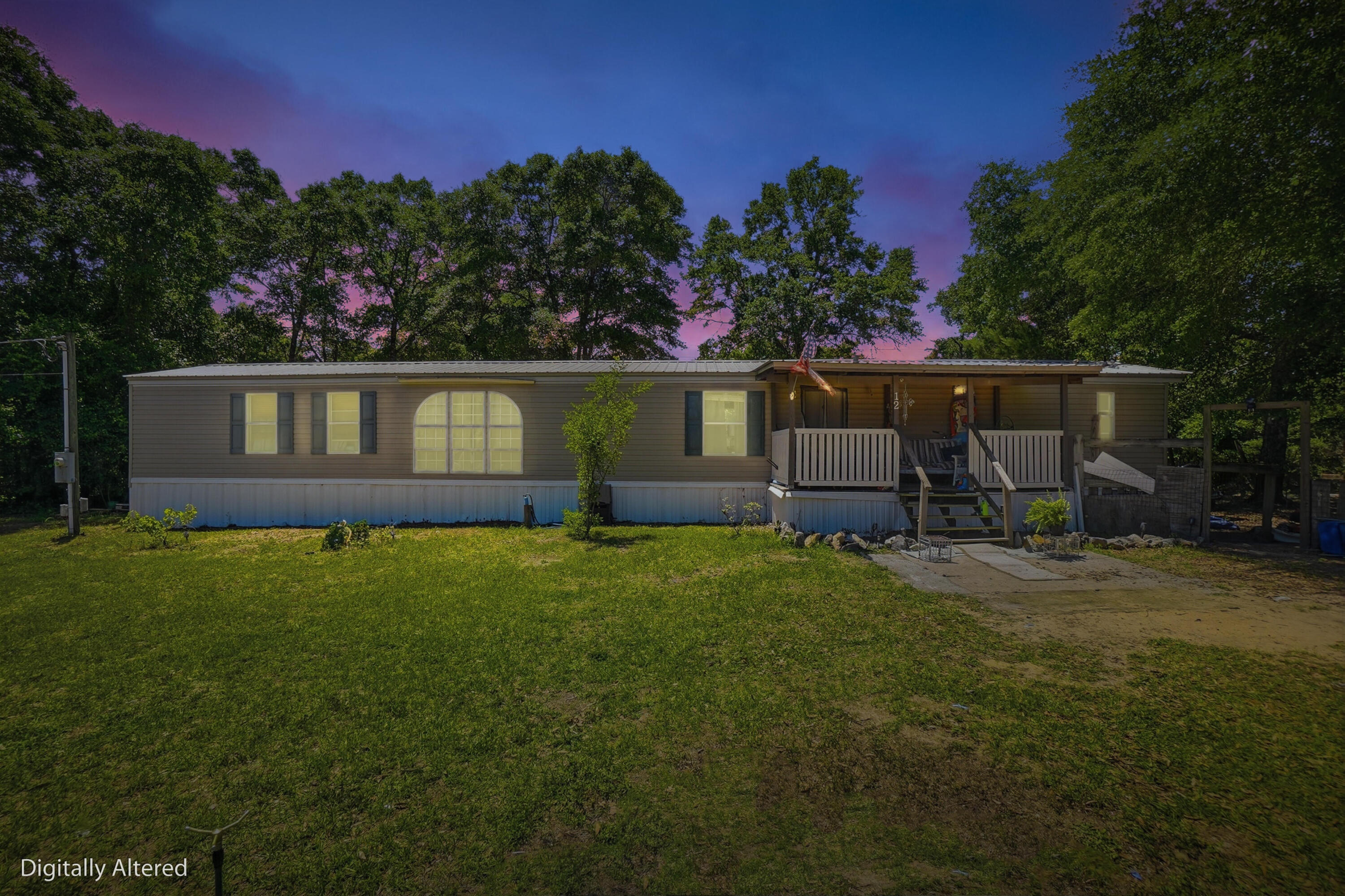 Nice mobile home situated on two lots totaling approximately 0.57 acres, conveniently located near Highway 90 with no HOA. This property offers plenty of space with a large fenced-in backyard, perfect for pets, outdoor activities, or additional storage.Major updates include a new HVAC system in 2025 and a new roof in 2019, which are both great improvements for a buyer.

The home features 3 bedrooms and 2 bathrooms, with the current layout converted into a 2-bedroom configuration for a larger living space, but it can easily be converted back to a full 3-bedroom if desired. The master suite includes a walk-in closet, garden tub, and a separate walk-in shower.

Enjoy outdoor living with a large covered front porch, along with additional deck space. The property also includes a yard building for extra storage.

The kitchen comes equipped with a refrigerator and stove, and the home offers vinyl flooring, central HVAC, and washer/dryer hookups.

While the home could use a little TLC, it is move-in ready and presents a great opportunity for a primary residence, rental, or investment property.

Situated on a corner, level lot with easy access via a maintained county road, this property offers both convenience and flexibility.