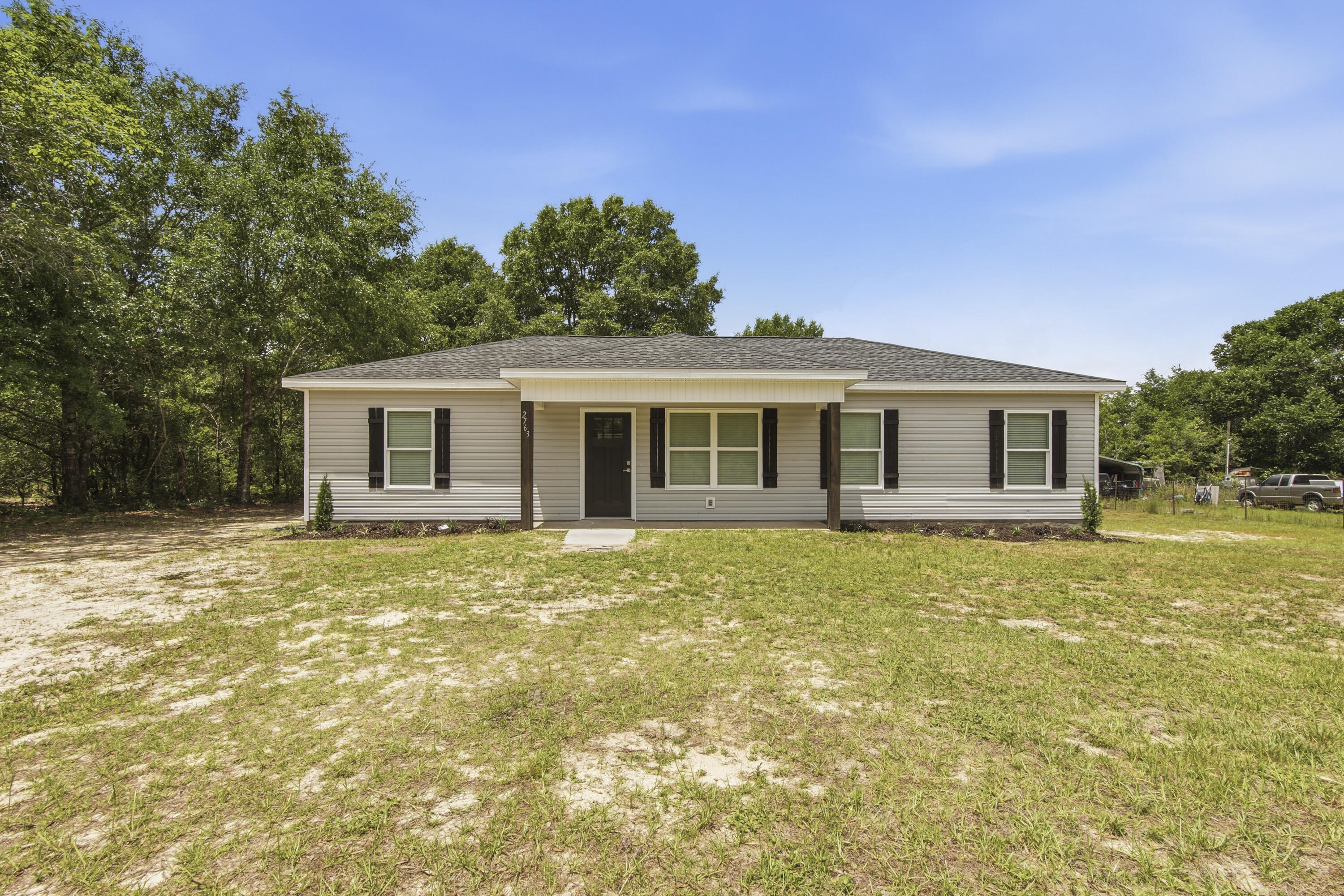 Welcome to 2763 Oak Ridge Road where wide open skies meet everyday comfort.  Nestles on nearly an acre of land in the heart of the Florida panhandle, this well built 2008 home offers four bedrooms with a split floor plan, two full baths across 1200 square feet of easy, efficient living.
The .78 acre lot gives you room to breathe, garden, add outbuildings, or simply enjoy the quiet of country life while staying connected to everything DeFuniak Springs has to offer, a charming historic downtown, local dining, easy I-10 access, and less than an hour's drive to the sugar white sands of the Emerald Coast.
What truly sets this property apart is the metal hangar, a rare and highly versatile structure perfect for hobbyists, contractors, or anyone needing serious workspace.  Whether you are using it for  a boat, a small RV, equipment, or running a home based business, this is the kind of bonus you don't just find at this price point.
All kitchen appliances and washer/dryer convey.
Buyer to verify all information deemed important.