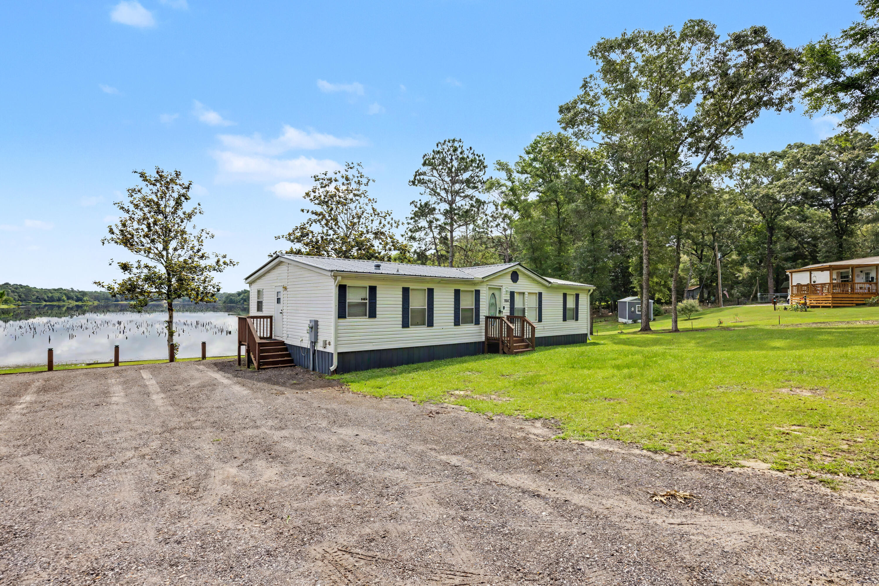 Welcome to your own private slice of paradise on sought-after Kings Lake Boulevard! Nestled at the end of a quiet street, this meticulously maintained waterfront home offers peaceful living with breathtaking views of beautiful Kings Lake -- a lake well-known for being fully stocked with fish and perfect for relaxing afternoons on the water. Inside, you'll find durable and stylish LVP flooring, and new carpet in the bedrooms, creating a seamless and modern feel. The home has been thoughtfully updated with a new roof and a new porches, giving you the perfect place to unwind while overlooking the sparkling lake views. Additional features include a full gutter system and irrigation system for easy maintenance and added convenience. Whether you're enjoying your morning coffee overlooking the water, fishing from your backyard, or simply soaking in the serene setting, this home truly offers the best of waterfront living.Tucked away for added privacy while still conveniently located, this Kings Lake gem is one you don't want to miss!
