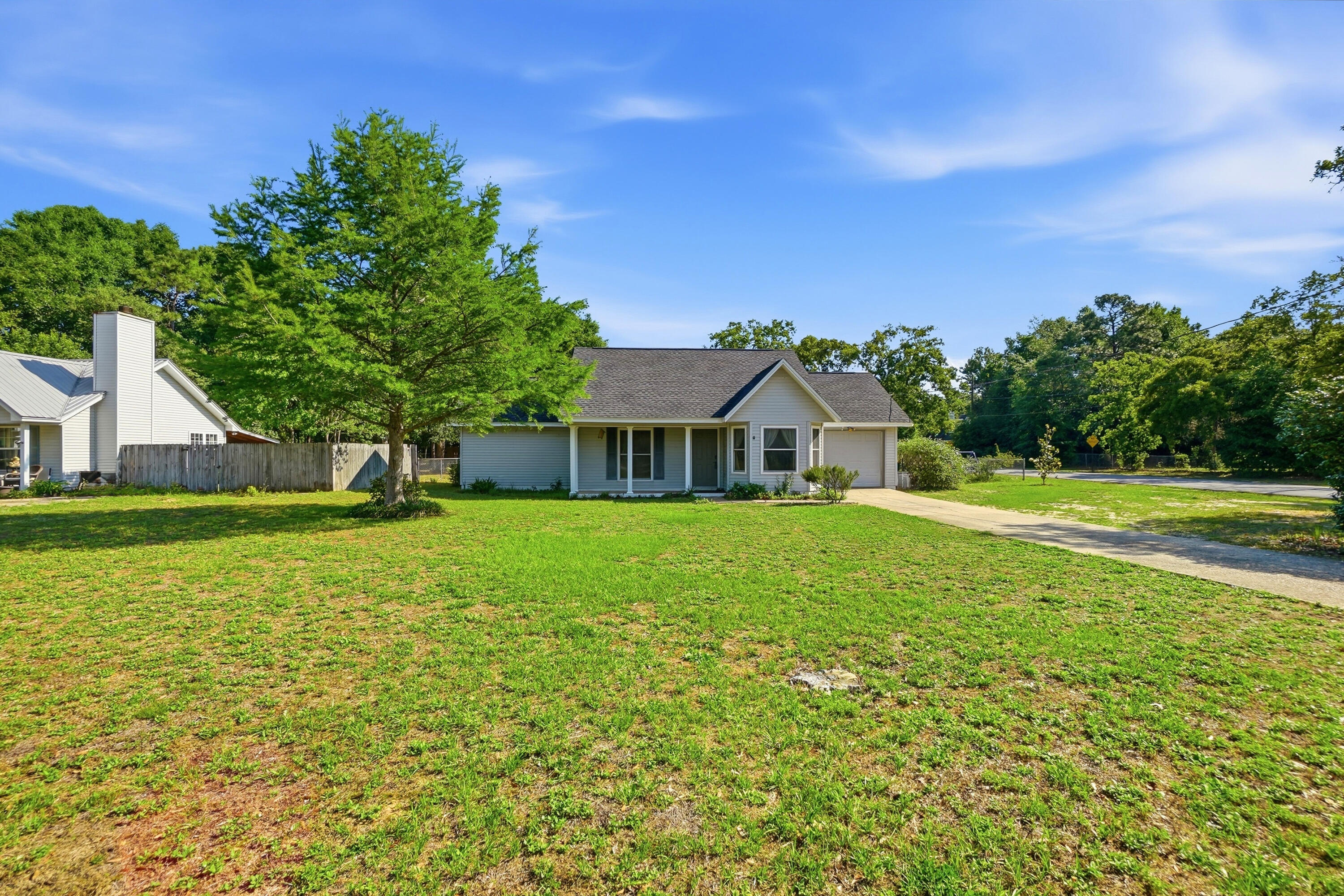 Located on a spacious half-acre corner lot, this beautifully updated 3-bedroom, 2-bath home at 324 John King Rd offers comfort, durability, and quality upgrades throughout. Major systems have already been taken care of with a new roof and HVAC installed in 2022, plus a water heater replaced in 2021 for added peace of mind.

Built with both style and strength in mind, the home features a 140 MPH wind-load rated garage door, four steel exterior doors, and energy-efficient Pella Thermastar double-hung windows filled with argon gas. Inside, you'll find tile flooring throughout the main living areas and bathrooms, complemented by warm bamboo wood flooring in the primary bedroom. The spacious primary suite also includes a beautifully tiled walk-in shower.

Additional upgrades include solid core interior doors leading to all bedrooms, bathrooms, and the living room closet, providing enhanced privacy and quality craftsmanship throughout the home. With its oversized lot, thoughtful improvements, and move-in ready condition, this Crestview property is one you won't want to miss!