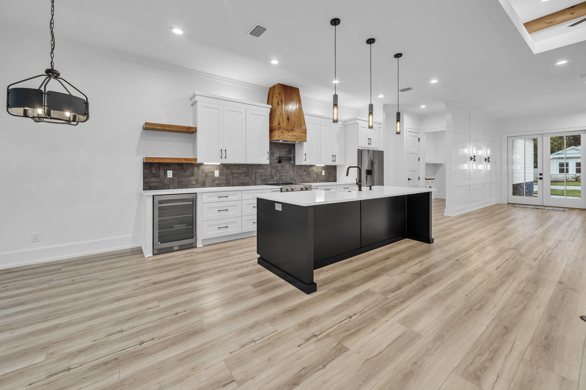 This highly-crafted Modern Farmhouse with refined Coastal Craftsman style, situated on an oversized lot, is now MOVE-IN READY! Presented by one of South Walton's most highly tenured and respected builders, Limbach Development, Inc., this exceptional new construction reflects the quality, craftsmanship, and intentional design synonymous with their work. It offers a rare blend of timeless architectural style and elevated coastal living.

Ideally located in the sought-after resort-style community of Bear Creek in South Freeport, this single-level residence offers 2,421 square feet with 4 bedrooms and 3 baths, designed for both luxury and everyday functionality.

From the moment you enter, elevated details set the tone--10-foot ceilings, a subtly illuminated 12-foot tray ceiling with Cypress beams, designer finishes, and a warm, inviting architectural aesthetic throughout. The open-concept living, kitchen, dining, and breakfast spaces are filled with natural light and centered around a stately kitchen island with seating for four. Designed for both elevated entertaining and everyday living, the gourmet kitchen features a premium KitchenAid appliance package, Sharp microwave drawer, and a custom-built Pecky Cypress vent hood, with matching shelving extending into the beautifully appointed wine bar. The split-bedroom layout enhances privacy, with a true primary retreat featuring a spa-like bath with freestanding tub, illuminated anti-fog mirrors, oversized walk-in shower, and a showstopping built-in custom closet with an 8-drawer dresser. Guest spaces include a private suite-style bedroom with barn door partition.

Outdoor living is equally impressive with extended covered front and rear porches featuring tongue-and-groove cedar ceilings, cedar columns, shutters, and a seamless indoor-outdoor flow. The home also opens to an exceptional wooded backyard setting--private, peaceful, and full of potential--ideal for a future pool, outdoor living expansion, pets, children at play, or simply creating your own backyard retreat surrounded by nature.

Smart home and efficiency upgrades include integrated audio wiring (living, primary bath, and porch), landscape speakers, security system readiness, WiFi boosters, MyQ-enabled garage, foam roof insulation, impact-rated windows and doors, and abundant attic storage. Exterior craftsmanship includes a paver driveway, stone and cedar accents, even 6.5" Galvalume gutters -- all contributing to elevated coastal curb appeal.

Bear Creek offers an unmatched resort-style lifestyle in South Freeport, with pools (including zero-entry), clubhouse, fitness center, tennis, pickleball, basketball, playgrounds, and green space. The location is just minutes to Grady Brown Park and bay access, and approximately 15 minutes to the beaches, dining, and shopping of Scenic 30A--offering the perfect balance of bay life, beach life, and community living.

A rare opportunity to own a thoughtfully designed, move-in ready home where luxury, function, and location align.

*All listing details are deemed reliable but not guaranteed. Buyer to verify all information deemed important.