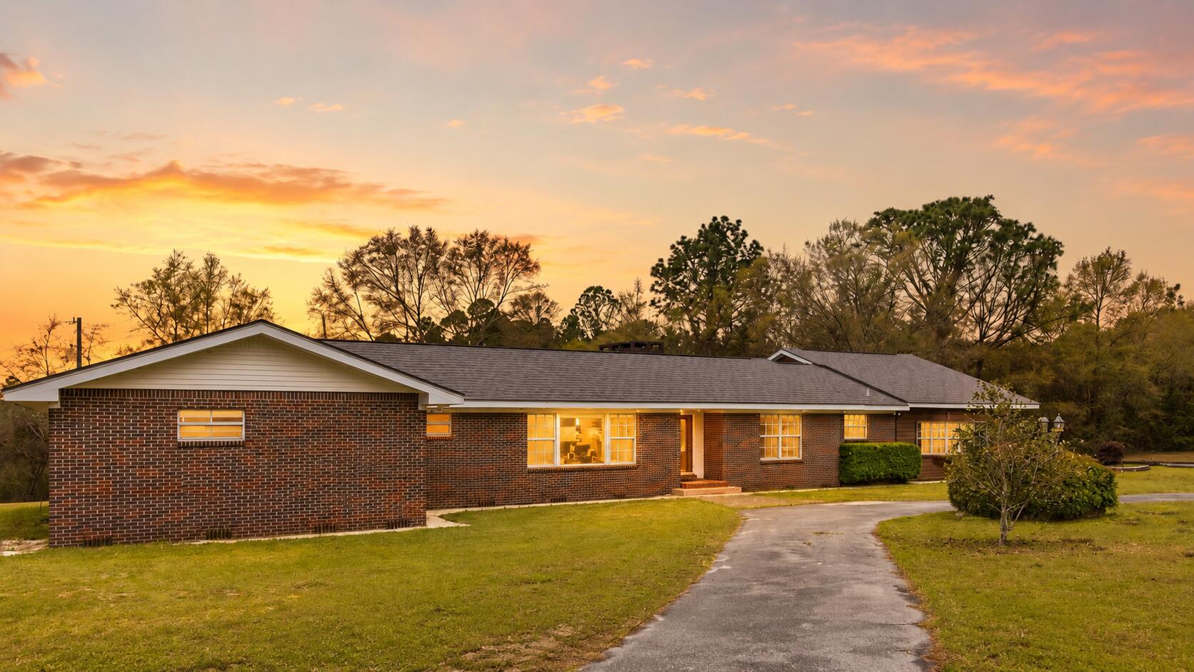 Unique ranch-style home on approximately 10.08 acres in Crestview! Located at 6475 Garden City Road, this spacious 4-bedroom, 3-bath property offers over 3,000 square feet with multiple living areas, including a formal living room, dining room, large recreational room, and comfortable main living area with a wood-burning fireplace. Interior features include warm wood floors, custom wood cabinetry, granite countertops, built-ins, brick accents, and classic character throughout. The updated master bathroom adds a nice modern touch, while the flexible layout provides plenty of room for entertaining, working from home, hobbies, or guest space. Outside, enjoy mature trees, open yard space, a small pond behind the home, multiple additional buildings for storage or workshop use, covered parking options, and a 2-car garage. A rare opportunity to own acreage, privacy, space, and character in Crestview