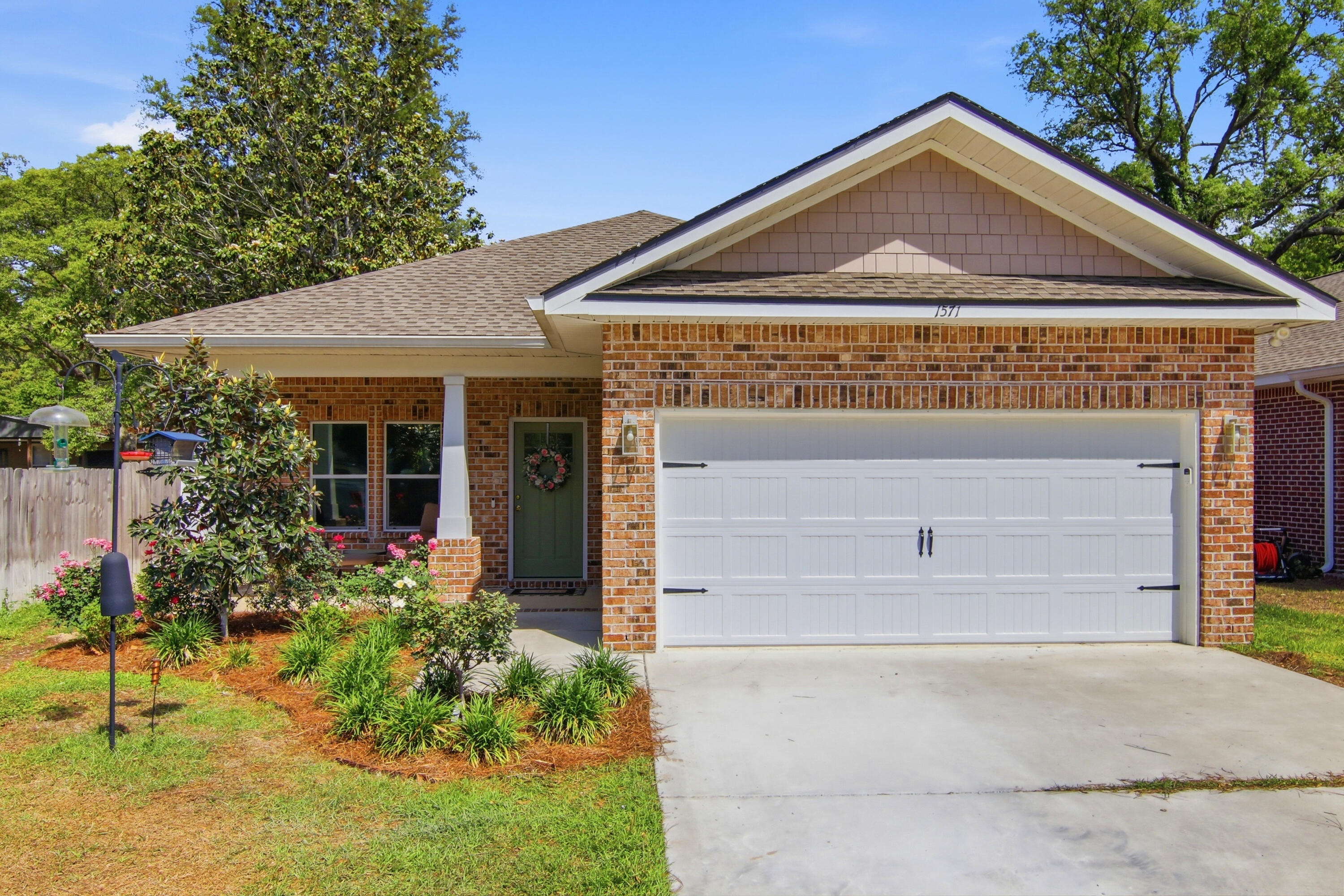 Approximately 2,200 square feet of inviting living space awaits in this four-bedroom, two-bathroom house. The charming brick exterior and covered porch create an instantly welcoming atmosphere. Step inside to discover an open concept layout filled with abundant natural light and luxury vinyl plank flooring throughout.The spacious kitchen boasts modern appliances, ample cabinetry, and an elegant lighting fixture, seamlessly flowing into the dining area. The primary bedroom offers ample natural light and a spacious layout, while the additional three bedrooms provide comfortable accommodations. Step outside to the sizable backyard, where a covered patio invites you to relax and enjoy the outdoors. Located in an A+ School district and close to the beaches of Destin, Eglin AFB and 7th Group.