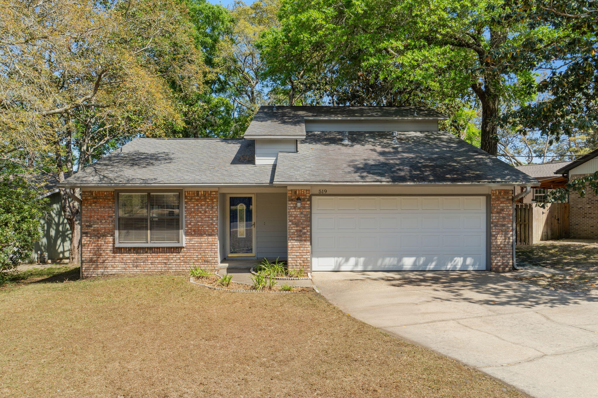 Located in the heart of Niceville, 519 Mathew Street offers the ideal combination of exactly what you have been looking for. This well-maintained 3-bedroom, 2-bath home features 1,532 square feet of living space, just minutes from top-rated schools, shopping, and local military bases. The spacious eat-in kitchen is equipped with ample cabinet and counter space, a breakfast bar, and a stylish tile backsplash.  The main living showcases hardwood floors, a soaring cathedral ceiling, and a cozy corner gas fireplace, all enhanced by the abundance of natural light.
The main-floor master bedroom provides a private retreat with 2 closets and an updated bathroom featuring a custom tile tub surround and separate vanity areas. Upstairs bedrooms each offer private balcony access overlooking the backyard, creating a unique and inviting space for family or guests. Step outside to enjoy a large fenced backyard complete with a deck, ideal for entertaining, relaxing, or enjoying Florida's year-round lifestyle. 
Move-in ready, centrally located, and exceptional value in Niceville. This house has what you have been looking for. Yard shed to convey in AS IS Condition No Value.