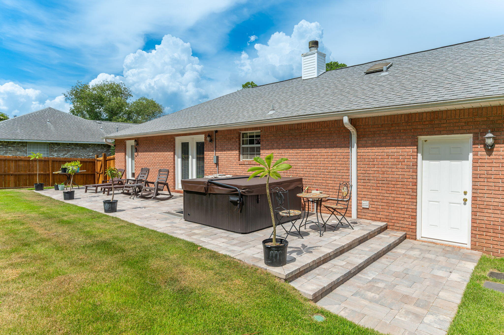 Welcome to this charming all-brick 3-bedroom, 2-bath home in the much-coveted and sought-after Holley by the Sea community. This one-level split floor plan offers easy living with no carpet, a 2022 roof, upgraded appliances added in 2026, ceramic tile in the entry, kitchen, dining, and baths, plus LVP wood flooring in the living room. A cozy fireplace adds warmth and character, while the private primary suite is tucked away from the guest bedrooms. French glass doors off the dining area lead to a peaceful backyard retreat with upgraded landscaping, palm trees, a pergola deck, and space to relax or entertain. This home also comes with a new hot tub, Zero Turn John Deere mower, washer, and dryer, adding even more value to this inviting Navarre home.