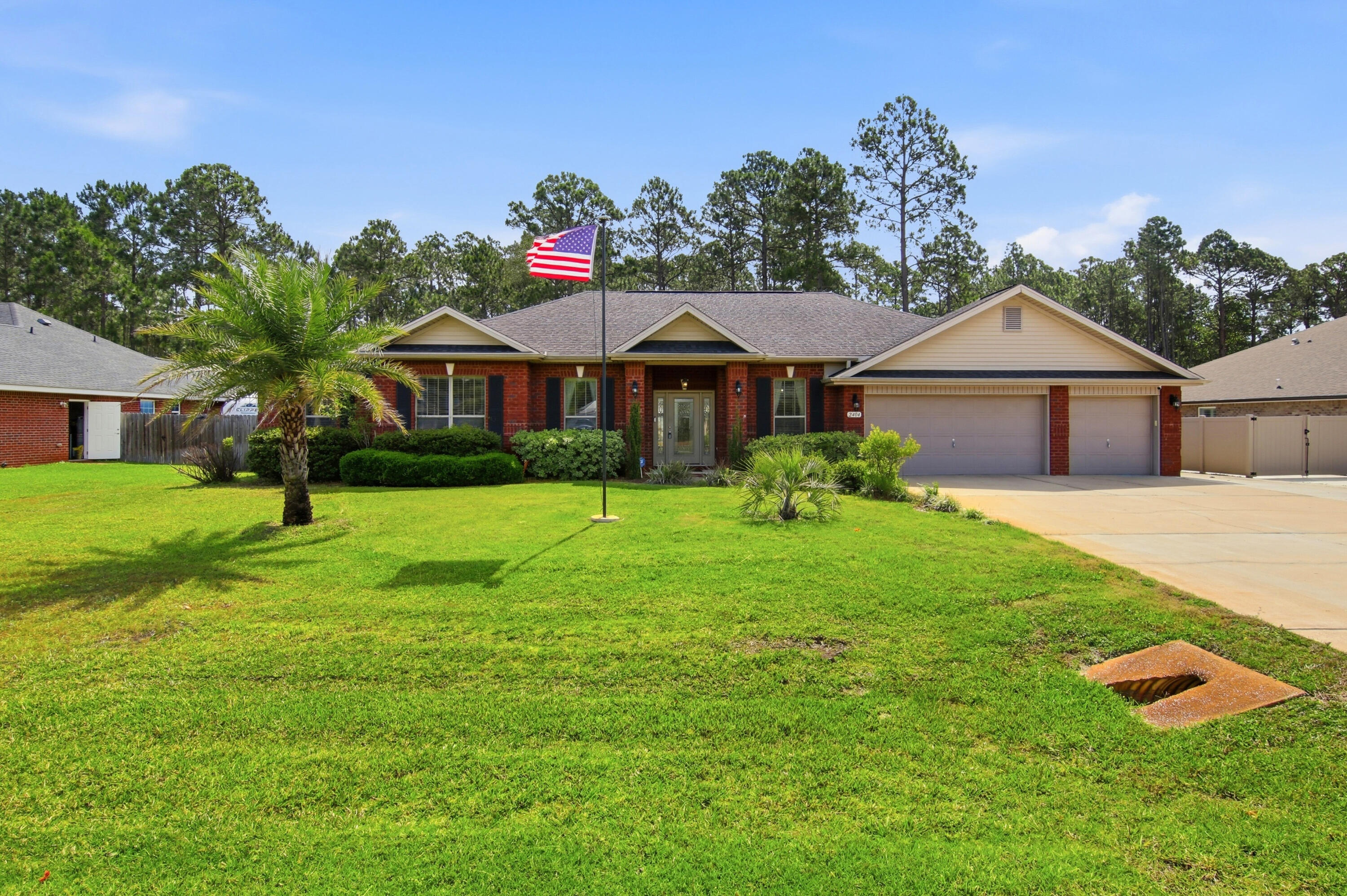Located in the highly sought-after community of Holley by the Sea in Navarre, this beautifully maintained residence offers an exceptional blend of comfort, privacy, and refined coastal living. Set on an expansive .58-acre homesite surrounded by mature trees, the property provides a rare sense of space and seclusion while still being part of one of the area's most desirable neighborhoods. Inside, you're welcomed by a thoughtfully designed split floor plan featuring four spacious bedrooms, two full bathrooms, and a dedicated private office--ideal for remote work or a quiet study without sacrificing a bedroom. The interior is enhanced with durable COREtec wood-look plank flooring throughout the main living areas and bedrooms, creating a cohesive and modern feel with no carpet in sight.

At the center of the home, the kitchen is designed for both everyday living and entertaining, offering granite countertops, stainless steel appliances, a high-top breakfast bar, a generous pantry, and a bright breakfast nook that fills the space with natural light.

The primary suite is a true retreat, accessed through elegant French doors and offering an oversized layout with plenty of room to unwind. The en-suite bath impresses with its scale and features, including an expansive walk-in shower and abundant space throughout. On the opposite side of the home, the additional bedrooms provide privacy and convenience, with the second bathroom offering direct access to the backyard--perfect for outdoor living and entertaining.

One of the standout features of this property is the immaculate three-car garage, complete with a glossy epoxy floor finish and built-in storage cabinetry, making it as functional as it is impressive.

The exterior living spaces are equally inviting, featuring a fully fenced backyard, covered patio, and a wood deck that overlooks the natural wooded backdrop. Additional highlights include a sprinkler system on a private well, underground utilities, Levelor blinds throughout, fabric hurricane window protection, and sewer service (no septic).

This is a rare opportunity to own a spacious, well-appointed home in Holley by the Sea that offers both privacy and convenience, all within a highly desirable coastal community with incredible amenities and lifestyle appeal