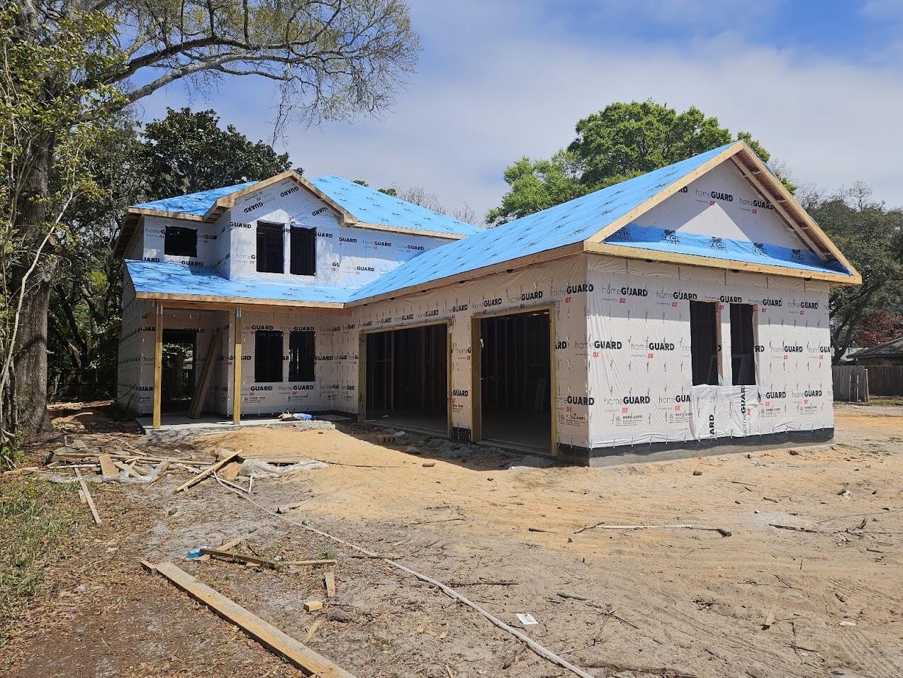 Stunning new-construction two-story home with bay views, 3-car garage.  Completion in 30 days. Ideal for a growing family, it features a main-level primary suite plus a guest suite and a office/flex room that can serve as a 7th bedroom, four bedrooms upstairs, with separate laundry rooms on both levels. Interior finishes (sheetrock and trim in progress) include a shiplap entry wall,  drop zone, custom-built hood vent, built-in dry bar with 130-can beverage fridge, floating shelves and accent lighting, pewter-green main-floor laundry cabinets with checked tile, master bath accent wall of green subway tile in a basket-weave pattern, and a shower with dual valves, fixed head and handheld. Three sconce lights line the stairs. Short walk to Meigs neighborhood beach, boat ramp & picnic area.