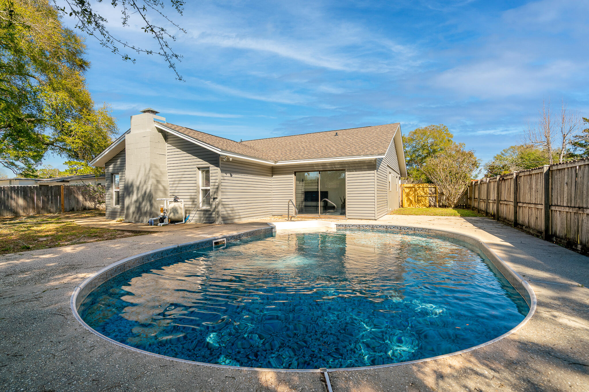 Welcome to this charming 3-bedroom, 2-bathroom home located in the vibrant city of Mary Esther, FL. This property boasts a spacious living room, perfect for entertaining or relaxing after a long day. The kitchen is equipped with modern stainless-steel appliances and updated fixtures. The luxury vinyl plank flooring throughout the home adds a touch of elegance and is easy to maintain. Step outside to a fenced-in yard, providing a private space for outdoor activities. The front porch is an inviting space to enjoy your morning coffee or unwind in the evening. As an added bonus, this home features a pool, perfect for cooling off during those hot Florida summers. This home is a perfect blend of comfort and modern living. Don't miss out on this gem in Mary Esther!