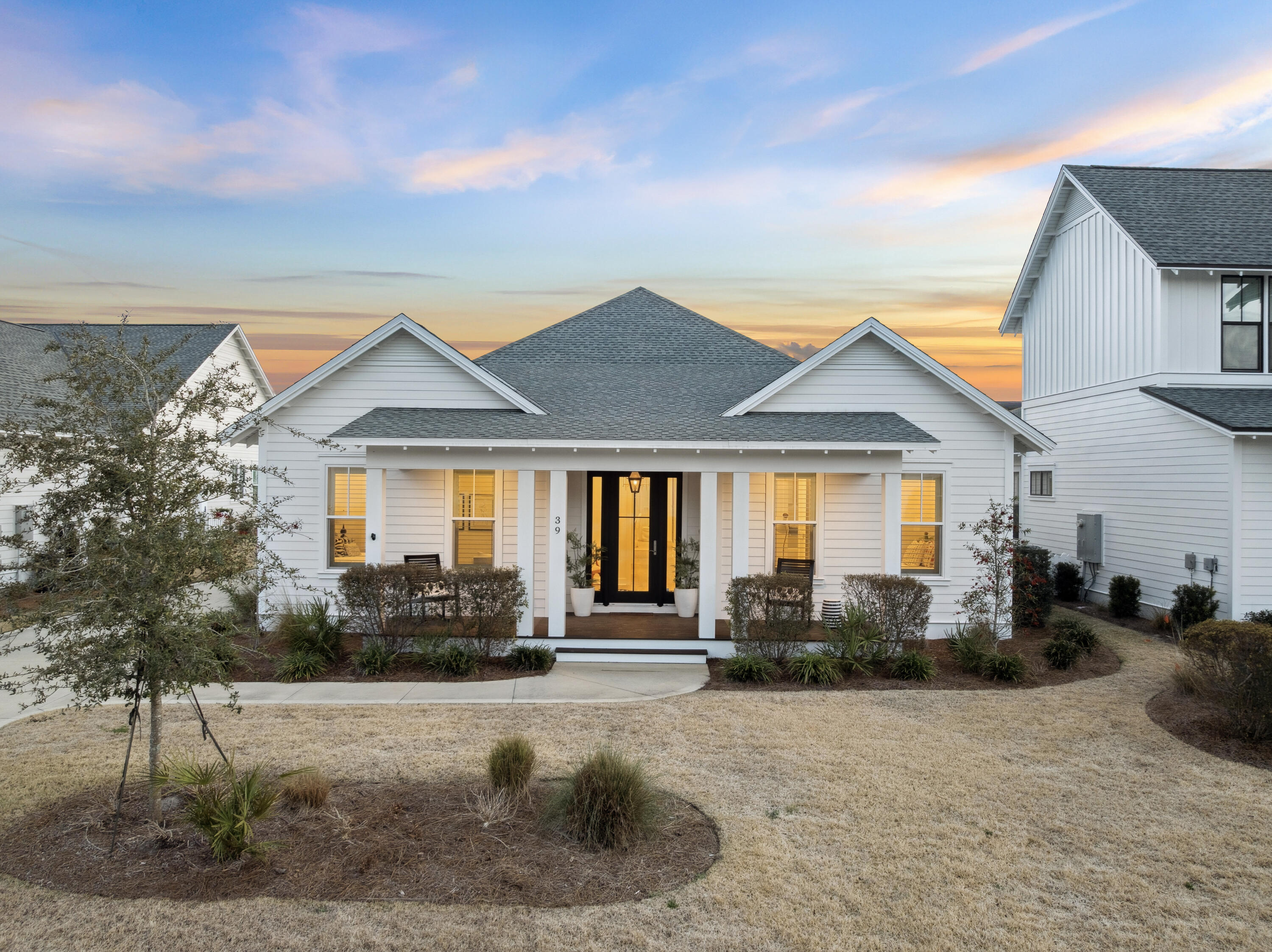 Positioned within the sought-after Watersound Origins community, 39 West Firethorn Circle presents a refined coastal retreat defined by timeless architecture, thoughtful design, and seamless indoor-outdoor living. Framed by classic coastal elevations and welcoming front and rear porches, this one-level, easily accessible residence offers both comfort and understated sophistication. Spanning approximately 2,612 square feet, the four-bedroom, three-bath home is designed for effortless living. Inside, wide-plank wood flooring, soaring 10-foot ceilings, and abundant natural light create a bright and inviting atmosphere throughout. The open-concept living spaces are anchored by a shiplap fireplace wall and flow seamlessly into the gourmet kitchen, where quartz countertops, custom cabinetry, stainless steel appliances, and an expansive center island provide both function and a natural gathering space for entertaining. Designer lighting and curated finishes elevate each space while maintaining a relaxed coastal aesthetic.

The thoughtfully designed floor plan offers four spacious bedrooms and three full bathrooms, balancing privacy and connection. The primary suite serves as a private sanctuary with generous proportions, tranquil natural light, a spa-inspired bath with dual vanities, refined finishes, and a spacious walk-in closet.

Extending the living experience outdoors, the expansive, screened rear porch overlooks the fenced backyard, creating a private setting for year-round enjoyment and entertaining. A two-car garage adds convenience and additional storage.

Residents of Watersound Origins enjoy access to Village Commons amenities, including a resort-style pool, fitness center, tennis and pickleball courts, miles of walking and biking trails, and access to Lake Powell. Combined with proximity to Scenic Highway 30A, championship golf, dining, and the gulf's white-sand beaches, this residence offers an ideal balance of privacy, accessibility, and elevated coastal living.