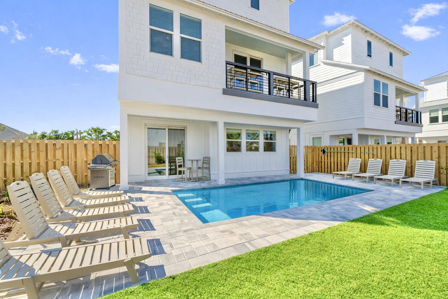 The current property management company is offering a $185,000 rental income guarantee for 2027, providing a compelling opportunity for investors seeking both immediate cash flow and downside protection. Welcome to 8 Blue Ohana Court in Miramar Beach, a fully furnished and turnkey 7-bedroom, 7.5-bath luxury vacation rental designed for strong short-term rental performance and immediate income generation. This spacious three-story home comfortably sleeps up to 22 guests and is being sold completely rental-ready, including a brand-new 6-seat street-legal golf cart, allowing for a seamless transition for any investor. The property already has over $120,000 in bookings secured for 2026 and is projected to finish the year at approximately $170,000 in rental income despite a delayed start in late February, with projected revenue for 2027 estimated between $190,000 and $210,000.

The home is purpose-built to maximize occupancy and revenue, featuring five king suites with private bathrooms and two high-capacity bunk rooms designed for large groups. The open-concept layout includes a chef's kitchen with a gas range, expansive living and dining areas, multiple lounge spaces, and a dedicated game room, all thoughtfully designed to enhance the guest experience. The private backyard offers a resort-style setting with a heated pool, covered outdoor living space, and ample room for entertaining, which are key drivers for repeat bookings and premium nightly rates. Multiple balconies and gathering areas throughout the home provide both privacy and functionality for large groups, and a community sand volleyball court is currently being constructed, adding another attractive amenity for guests and enhancing overall rental appeal.

Ideally located just about a one-minute golf cart ride to Miramar Beach's largest public beach access, the property offers easy access to the Gulf along with close proximity to Destin, Sandestin Resort, and Scenic Highway 30A. Guests benefit from nearby dining, shopping, and entertainment, further supporting consistent rental demand year-round. This property stands out as a high-performing, income-producing asset with future bookings already in place, professional management available, and no additional setup required, making it an exceptional opportunity for investors seeking a proven luxury vacation rental in one of the Emerald Coast's most desirable markets.