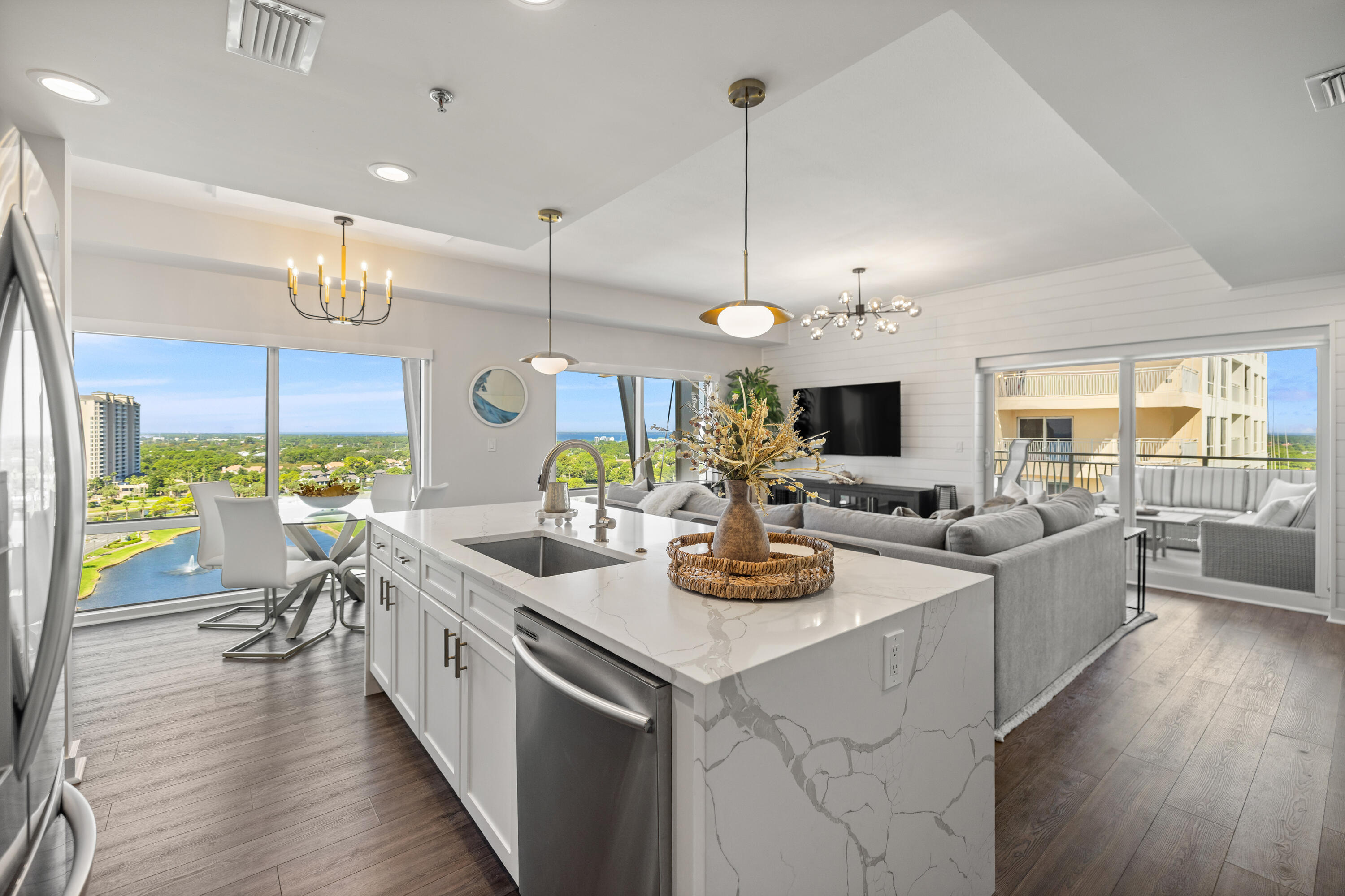 LUXURY BEACHSIDE PENTHOUSE! Located at the top of Luau II in the Sandestin Golf and Beach Resort! Being offered fully furnished this stunning 3BR & 3BA condo spans over 1,731 square feet. Enjoy the remarkable scenery from every room and two separate balconies, offering panoramic views of the Gulf, Beaches, Bay, Marina and Resort. The balconies provide ample space for outdoor dining, and relaxing.  Beautifully renovated and designer furnished with elegant Arhaus Furniture, reflecting a refined and upscale atmosphere throughout.  This condo presents multiple rental options, you can rent the entire unit as a spacious 3BR, 3BA, or opt to rent it as a 2BR, 2BA  with the studio available separately. These flexible arrangements cater to different guest needs and maximize rental potential. The Luau condominium features a spacious pool pavilion that includes a relaxing hot tub, grotto and waterfall. There is also a grilling area and during the summer months, a poolside snack hut. Luau owners and guests have gated garage parking. Additional Updates include HVAC replaced in 2025.