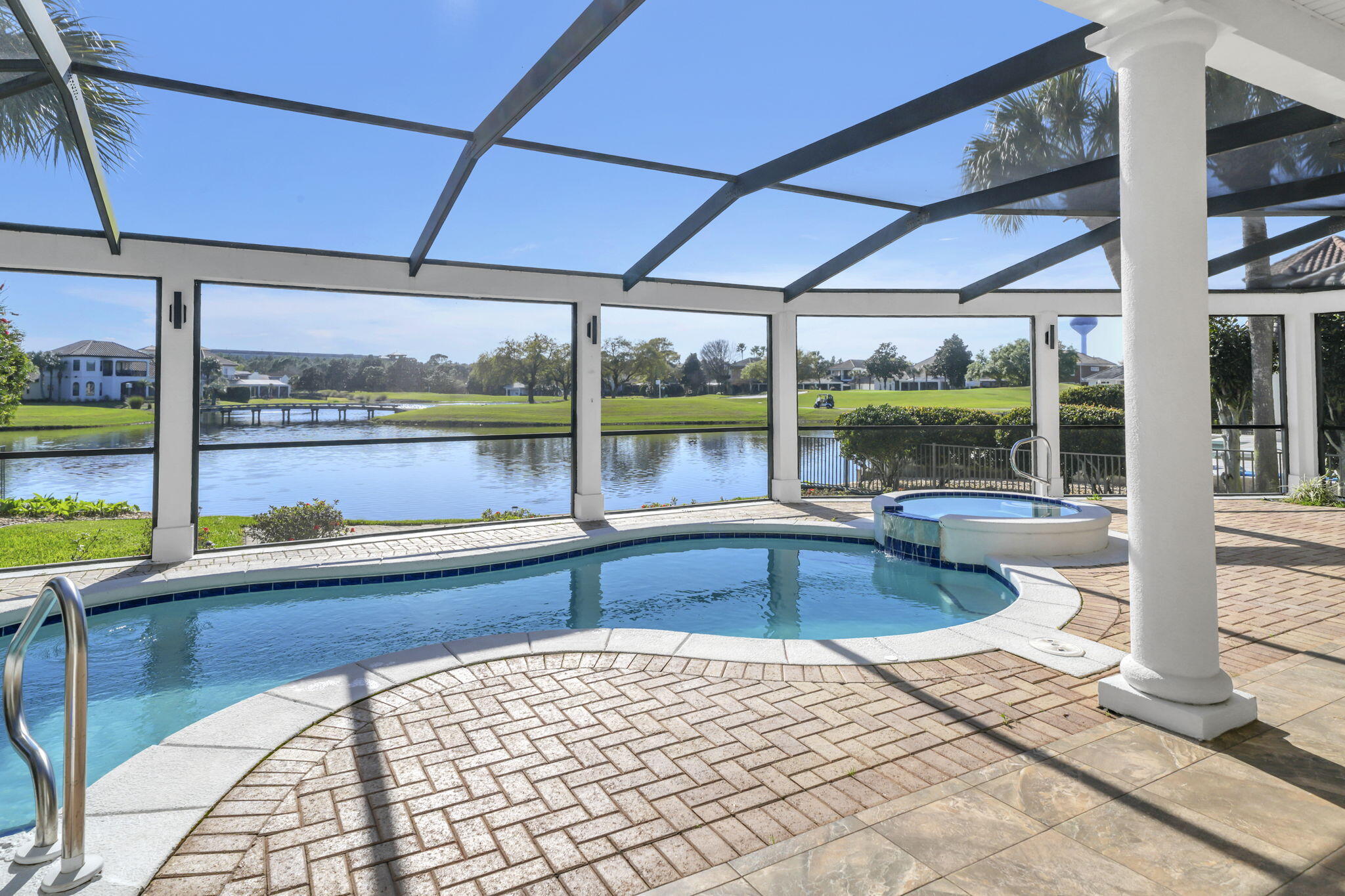 It's all about the VIEW! 503 Regatta Bay blvd is located lake front across from the 16th tee (no golf balls hit your home) in the prestigious Regatta Bay Lakes neighborhood.  This custom built home is excellent for entertaining with 20' ceilings, wide open spaces, a grand staircase, disappearing sliding glass doors that open on to the screened in pool lanai with non slip tile, hot tub, built in outdoor kitchen and plenty of room for seating that allows for al fresco dining while you watch the sunset nightly and fireworks 3 times a year bug free.  The pool bathroom helps keep water contained outside and comes with a shower to wash off the sand from the beach only 1.5 miles away.  There are door alarms for peace of mind with little ones too.  
The gourmet kitchen has custom dovetailed Schrock cabinets, built in SubZero fridge, 6 burner Dacor gas range, built in Thermador oven and microwave, a Miele dishwasher, and a wine/drink fridge. New emerald pearl quartzite countertops, a deep Blanco granite sink with a hot water dispenser and a water filter system along with a custom center island with a wood Boos block top complete the space.

This multigenerational home offers 2 large primary suites on the main level on opposite sides for privacy. The main master wing has 2 large walk-in closets with built in organizers and the other is ADA equipped and also has a large walk-in closet. Both suites have sliding glass doors that open on to the screened in lanai and oversized bathrooms with *Schrock custom cabinets and tons of storage. The large bright laundry room off the main primary wing has a huge picture window that adds lots of natural light, has more storage and is also accessible from the hallway off the 2 ½ car garage.

A dedicated office off of the sitting room has lots of storage with 2 custom built in desks and custom cabinets and shelving.

There are 2 additional bedrooms upstairs with new light white oak hardwood floors. Bedroom #3 has an attached fully remodeled bathroom and the versatile bedroom #4 has a kitchenette with new quartz countertops, seating and storage, a small sink, 2 mini fridges, and a small dishwasher. A spacious bedroom, guest suite, or media room as owners currently use the space, great for watching the game with friends and family. The bunkroom can be a massive walk-in closet or an ensuite bathroom depending on the next family's needs.

The upstairs spacious screened in covered lanai has amazing views of the golf course, lakes, and skyline and is perfect for reading a book or relaxing.

Too many updates to list (full list is attached to MLS) to include 2 new HVAC units, new hot water heater, new pool pump, new quartz in laundry room, new granite installed in outdoor kitchen with custom tile backsplash wall for easy clean up, interior recently painted, new ceiling fans, 8 new screen panels replaced after SNOW!

Tile floors downstairs are easy to keep clean (sand) and newer carpet is on stairs and landing only.

Owners also have a 4 point inspection report and wind mitigation report dated 10/2024 for low home insurance available. There is a Generac whole home generator, 2 termite bonds grandfathered in to the property and a charger for an electric car out front on the side of the home.

Regatta Bay is a private gated community within walking distance to shopping, dining, Whole Foods, Destin Middle School, Lulu's, Legendary Marina and the beautiful Destin beaches. A perfect oasis, rated a top GOLF course by Golf Digest magazine, rated the safest community in Destin. Come experience the Regatta Bay lifestyle and make 503 Regatta Bay your home today. Video is available on Youtube, look up by address.