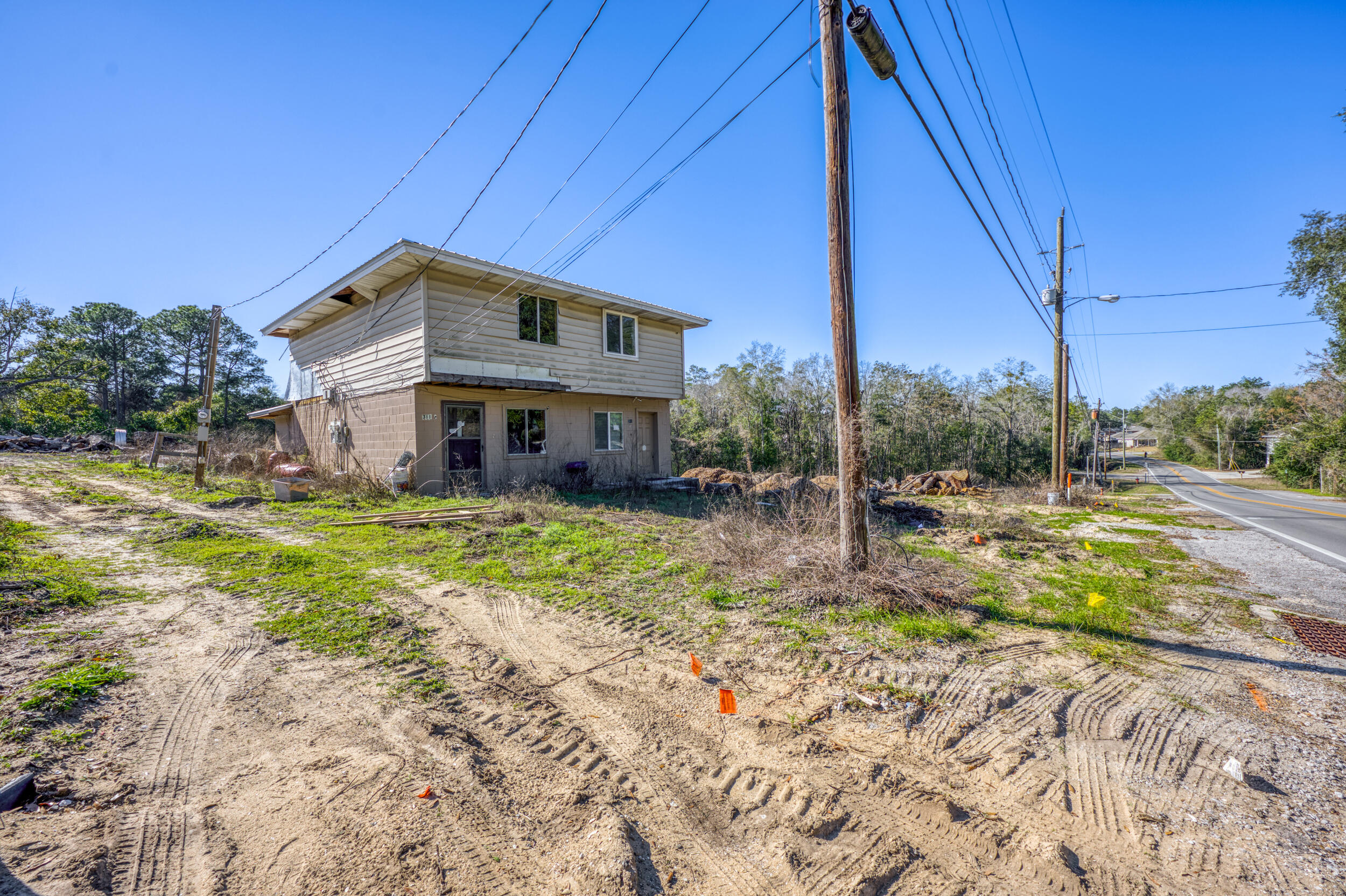 Opportunity to acquire a ±2.75-acre multi-parcel located within the City of Niceville Community Redevelopment Agency (CRA) district, offering strong redevelopment and investment potential. The property includes an existing duplex that needs renovation, providing a true value-add opportunity, and features a new metal roof, offering a solid starting point for improvements. With Multi-Use zoning, the existing structure may be suitable for conversion to office or professional space, subject to city approvals. A significant portion of the parcel remains vacant, allowing flexibility for additional mixed-use concepts, or expanded multi-family, making this an ideal site for investors or owner-users looking to reposition the property.