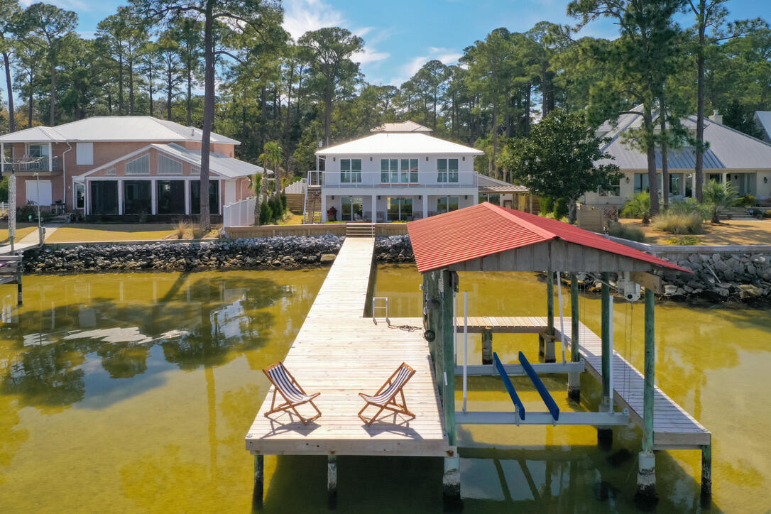 Rarely on the market, this newly renovated direct bay front home awaits you with a 2.75% assumable mortgage. No HOA and fully furnished. Great investment home! Rented first time in summer of 2026 averaging $1,000 to $1,500 per night! Wake up to a waterfront oasis, with a private dock& boat lift. Carriage house and 3 car garage plans are included. Walk into luxury with real wood flooring throughout the house, and beautifully designed interior. High end finishings in the kitchen, gas stove, wine closet, marble fireplace, & marble tiles from floor to ceiling in all bathrooms with waterfall quartz countertops in the kitchen & master bathroom. Rooms are equipped with remote controlled window treatment, easy access to the unparalleled sunrise rays & sunset hues. Master bedroom features a large walk-in closet, washer/dryer & a breathtaking view. The home features a 2-car garage, a luscious yard, hot tube over looking the bay and two saunas. one on the second floor balcony and one inside the garage.  
Home insurance is $8,200 and flood insurance is $1,800 annual. Seller is a licensed broker.