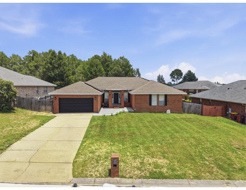 💥2.375% ASSUMABLE VA LOAN + PAID-OFF SOLAR = UNMATCHED SAVINGS! 💥 Welcome to your private sanctuary south of I-10!. This home offers a 2.375% interest rate, paid-off solar panels, and peace of mind with a NEW ROOF INSTALLED AT CLOSING WITH AN ACCEPTED OFFER! Step through the foyer where grand 10-ft ceilings sweep through the formal dining room and a versatile flex room. Fresh paint reflects the natural light, while a new hot water heater  serviced HVAC ensure worry-free living. Premium porcelain wood-look tile stretches throughout the entire home- no carpet anywhere! Soaring cathedral ceilings crown the light-filled great room, anchored by a cozy wood-burning fireplace. Throw open double French doors from any exit point into a fully enclosed, screened-in outdoor oasis featuring a  saltwater gunite pool! Backing up to peaceful green space, this backyard creates a rare feeling of secluded privacy even while living in one of the most sought-after subdivisions in South Crestview. The chef's dream kitchen is anchored by custom white oak cabinetry, a massive granite island, premium countertops, and clever pull-out storage, seamlessly connecting to a spacious laundry room and walk-in pantry. Escape to the expansive primary retreat featuring French doors opening directly to the pool allowing the soft glow of the water to welcome you daily. The primary bathroom is complete with dual vanities, soaking tub, walk in shower and massive wardrobe. Move-in ready! Make an Offer!