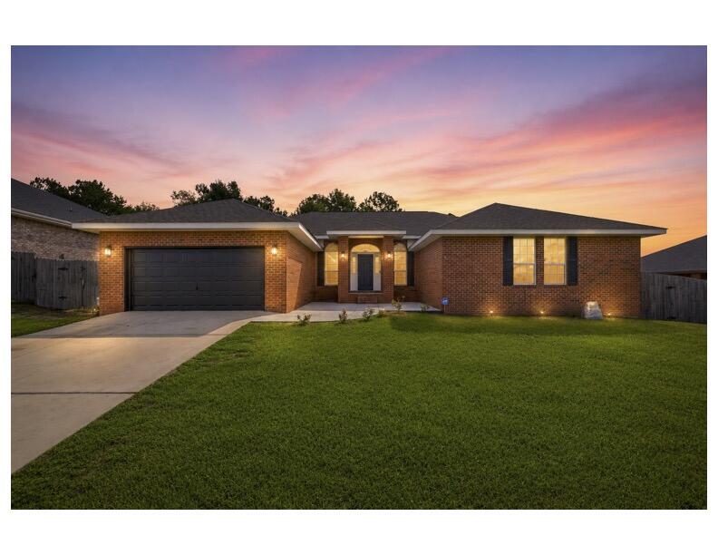 2.375% ASSUMABLE VA LOAN + PAID-OFF SOLAR = UNMATCHED SAVINGS!  Welcome to your private sanctuary south of I-10!. This home offers a 2.375% interest rate, paid-off solar panels, and peace of mind with a NEW ROOF INSTALLED AT CLOSING WITH AN ACCEPTED OFFER! Step through the foyer where grand 10-ft ceilings sweep through the formal dining room and a versatile flex room. Fresh paint reflects the natural light, while a new hot water heater  serviced HVAC ensure worry-free living. Premium porcelain wood-look tile stretches throughout the entire home- no carpet anywhere! Soaring cathedral ceilings crown the light-filled great room, anchored by a cozy wood-burning fireplace. Throw open double French doors from any exit point into a fully enclosed, screened-in outdoor oasis featuring a  saltwater gunite pool! Backing up to peaceful green space, this backyard creates a rare feeling of secluded privacy even while living in one of the most sought-after subdivisions in South Crestview. The chef's dream kitchen is anchored by custom white oak cabinetry, a massive granite island, premium countertops, and clever pull-out storage, seamlessly connecting to a spacious laundry room and walk-in pantry. Escape to the expansive primary retreat featuring French doors opening directly to the pool allowing the soft glow of the water to welcome you daily. The primary bathroom is complete with dual vanities, soaking tub, walk in shower and massive wardrobe. Move-in ready! Make an Offer!