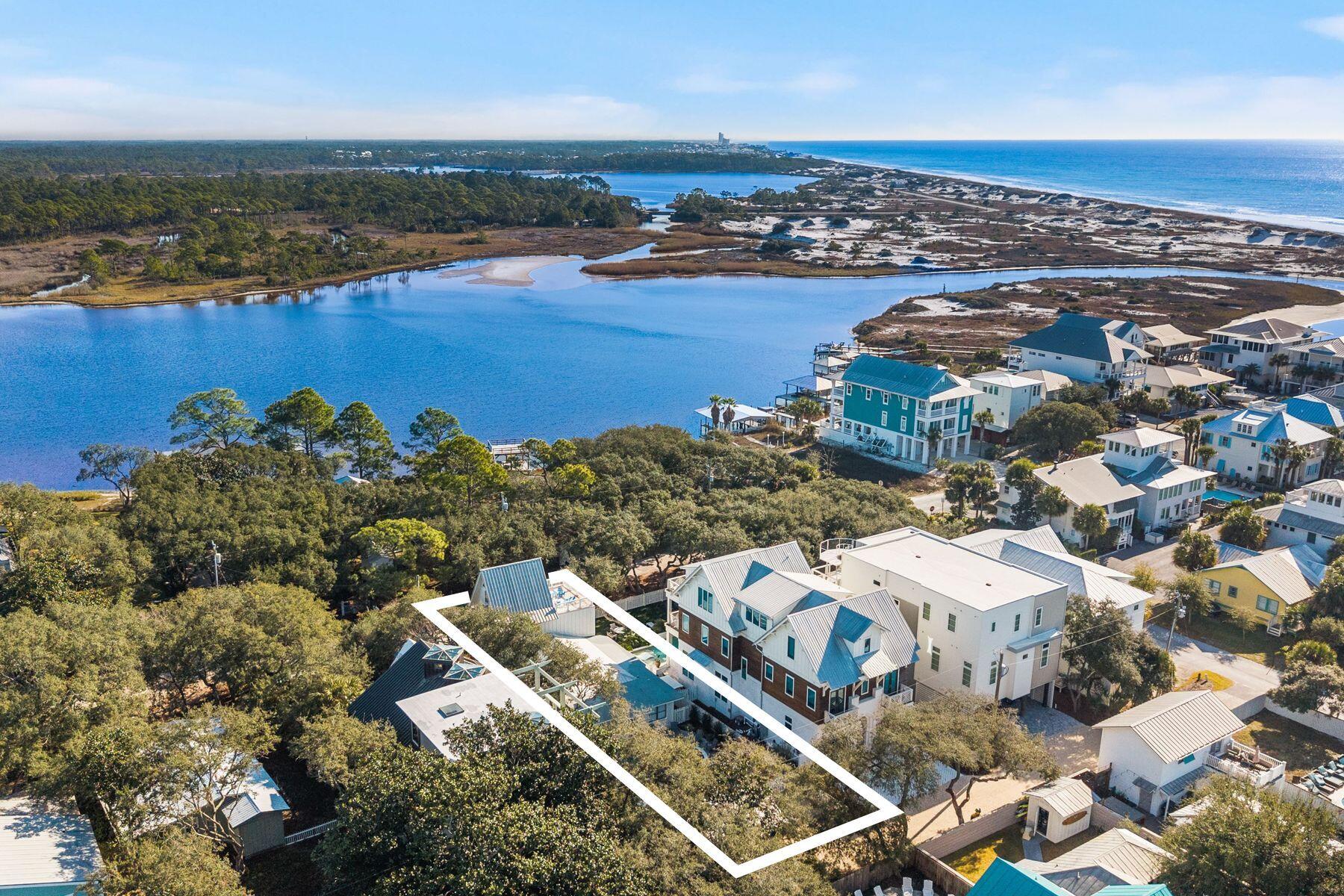 Timeless Grayton Beach character meets thoughtful modern renovation in this rare fully-furnished, dual-residence offering just steps from Western Lake, the shoreline, and the heart of one of 30A's most storied beach villages. Originally built in 1970 and extensively reimagined, the property pairs a gracious main home with a fully detached private cottage, creating flexibility for hosting, multigenerational living, or income potential without sacrificing privacy or charm.
The main residence spans approximately 2,910 square feet with five bedrooms and four-and-a-half baths across three levels. Recent updates include a fully redesigned kitchen, renovated bathrooms, fresh interior paint, new flooring, updated wiring and plumbing, two HVAC systems, new appliances, and a new roof. From the inviting front porch, morning coffee is enjoyed with tranquil views toward Western Lake. Inside, the first floor opens to a generous living and dining area that flows seamlessly into the kitchen, which offers ample space for an island and connects to a comfortable sitting or game room. A mudroom off the kitchen adds a half bath, a full-sized laundry, and direct access to the side yard for grilling.
Two first-floor bedrooms feature updated ensuite baths, while a rear hallway leads directly to the backyard. Upstairs, the second level offers two additional bedrooms and two full baths. The third floor serves as a flexible retreat or bedroom, highlighted by a striking wood A-frame ceiling with access to the large balcony.
The detached cottage provides approximately 560 square feet with one bedroom, one full bath, a family room, a full kitchen, a laundry room, an outdoor shower, and a separate entrance. With a new roof and alley access, the cottage allows easy movement to the beach, lake, and dining while remaining discreetly set apart from the main home.
Outdoor living is equally compelling, with a spacious backyard ready for relaxed afternoons, a newly added private pool, curated hardscape, and lush landscaping. After a day on the water, rinse off at the outdoor shower or unwind in one of several private seating areas. Parking is generous with a paver driveway, additional front parking, and two rear spaces for a total of seven. Accessibility has been carefully considered with a ramp on the north side and a fully accessible first floor, including the primary bath.
Both residences may be rented separately or together, offering exceptional versatility. Positioned moments from Western Lake, two beach accesses, and iconic spots like The Red Bar, Chiringo, and AJ's Grayton Beach, this is a rare opportunity to own a true Grayton Beach classic where coastal history, modern updates, and an unbeatable walkable setting come together with ease.