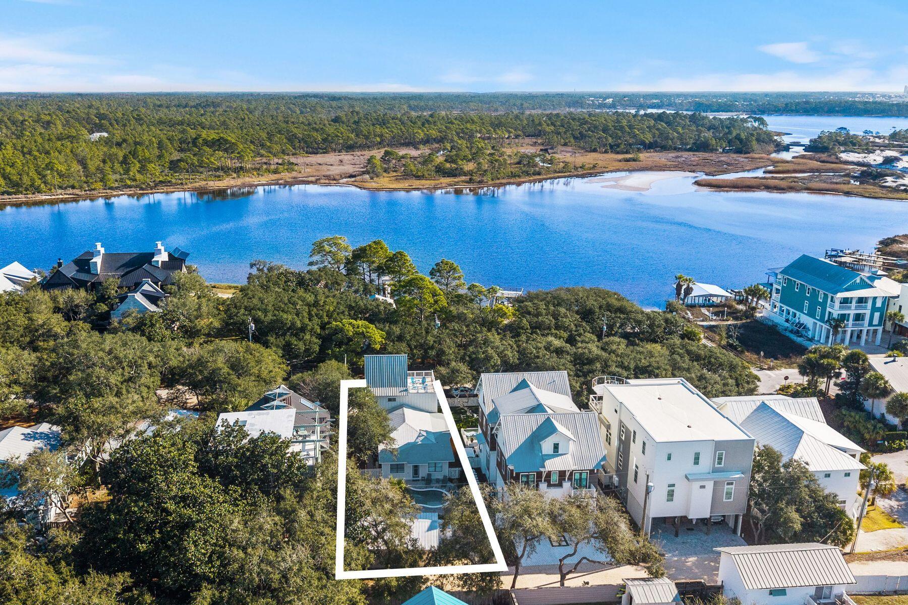 A Grayton Beach rarity: Western Lake views, a private guest cottage, and a resort-style pool combine to create a property as versatile as it is unforgettable.

Timeless Grayton Beach character meets thoughtful modern renovation in this rare fully-furnished, dual-residence offering just steps from Western Lake, the shoreline, and the heart of one of 30A's most storied beach villages. Originally built in 1970 and extensively reimagined, the property pairs a gracious main home with a fully detached private cottage, creating flexibility for hosting, multigenerational living, or income potential without sacrificing privacy or charm.
The main residence spans approximately 2,910 square feet with five bedrooms and four-and-a-half baths across three levels. Recent updates include a fully redesigned kitchen, renovated bathrooms, fresh interior paint, new flooring, updated wiring and plumbing, two HVAC systems, new appliances, and a new roof. From the inviting front porch, morning coffee is enjoyed with tranquil views toward Western Lake. Inside, the first floor opens to a generous living and dining area that flows seamlessly into the kitchen, which offers ample space for an island and connects to a comfortable sitting or game room. A mudroom off the kitchen adds a half bath, a full-sized laundry, and direct access to the side yard for grilling.
Two first-floor bedrooms feature updated ensuite baths, while a rear hallway leads directly to the backyard. Upstairs, the second level offers two additional bedrooms and two full baths. The third floor serves as a flexible retreat or bedroom, highlighted by a striking wood A-frame ceiling with access to the large balcony.
The detached cottage provides approximately 560 square feet with one bedroom, one full bath, a family room, a full kitchen, a laundry room, an outdoor shower, and a separate entrance. With a new roof and alley access, the cottage allows easy movement to the beach, lake, and dining while remaining discreetly set apart from the main home.
Outdoor living is equally compelling, with a spacious backyard ready for relaxed afternoons, a newly added private pool, curated hardscape, and lush landscaping. After a day on the water, rinse off at the outdoor shower or unwind in one of several private seating areas. Parking is generous with a paver driveway, additional front parking, and two rear spaces for a total of seven. Accessibility has been carefully considered with a ramp on the north side and a fully accessible first floor, including the primary bath.
Both residences may be rented separately or together, offering exceptional versatility. Positioned moments from Western Lake, two beach accesses, and iconic spots like The Red Bar, Chiringo, and AJ's Grayton Beach, this is a rare opportunity to own a true Grayton Beach classic where coastal history, modern updates, and an unbeatable walkable setting come together with ease.