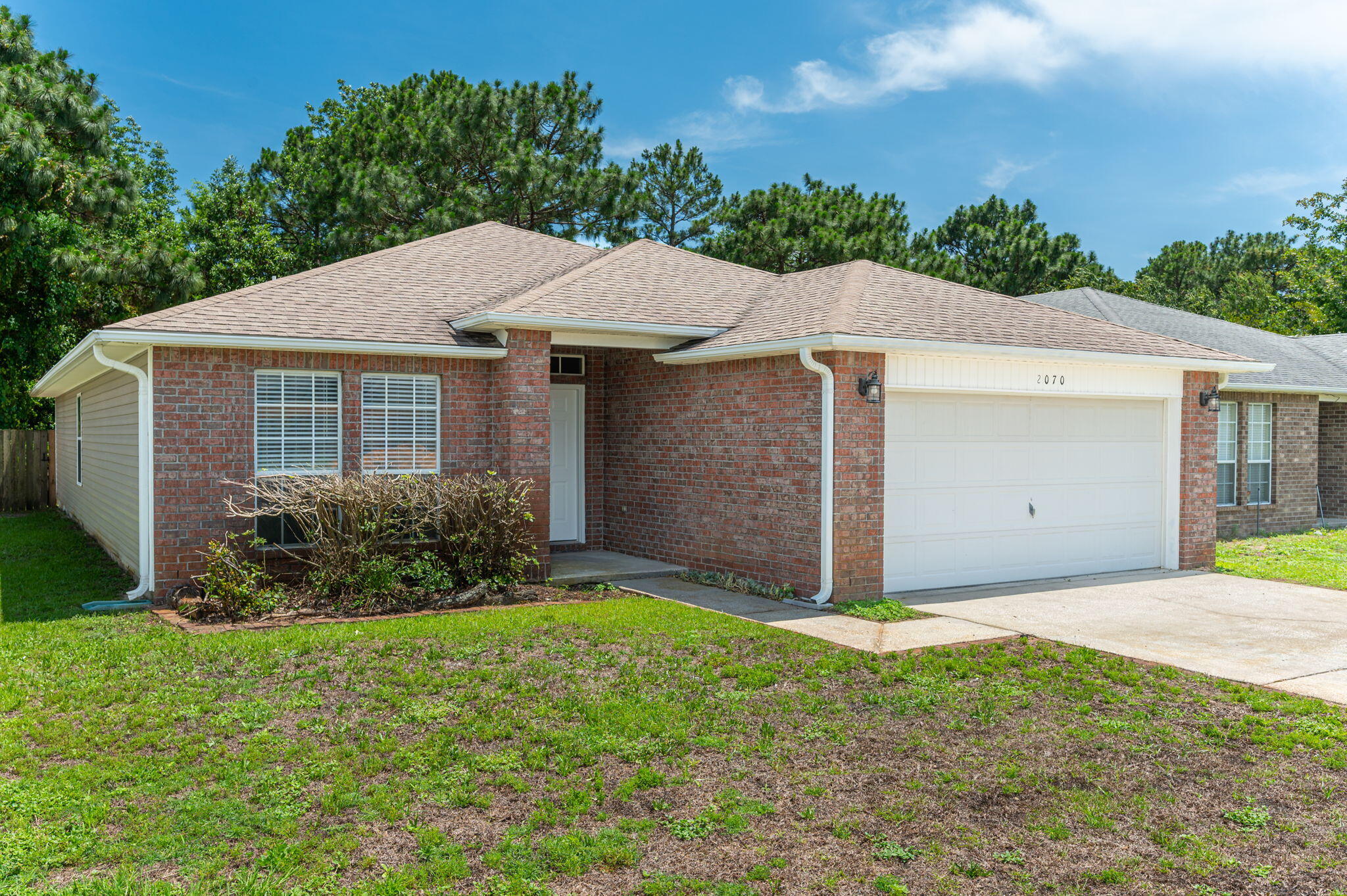Welcome to coastal living in Navarre! This beautiful 3-bedroom, 2-bath home is conveniently located less than 5 miles from Navarre Beach and just minutes from shopping, dining and nearby elementary and middle school. Situated in a neighborhood with underground utilities and NO HOA, this home offers both comfort and convenience. Inside, you'll find freshly painted interior walls, raised ceilings, and an open floor plan perfect for everyday living and entertaining. The kitchen features a breakfast bar, pantry, and ample counter space overlooking the living and dining areas. Relax in the Florida room, the perfect spot for your morning coffee or quiet time. The split-bedroom design provides privacy, while the primary suite offers a walk-in closet, double vanity, and a garden tub. Enjoy the fully fenced backyard backing up to a protected wooded area, providing added privacy with no rear neighbors.