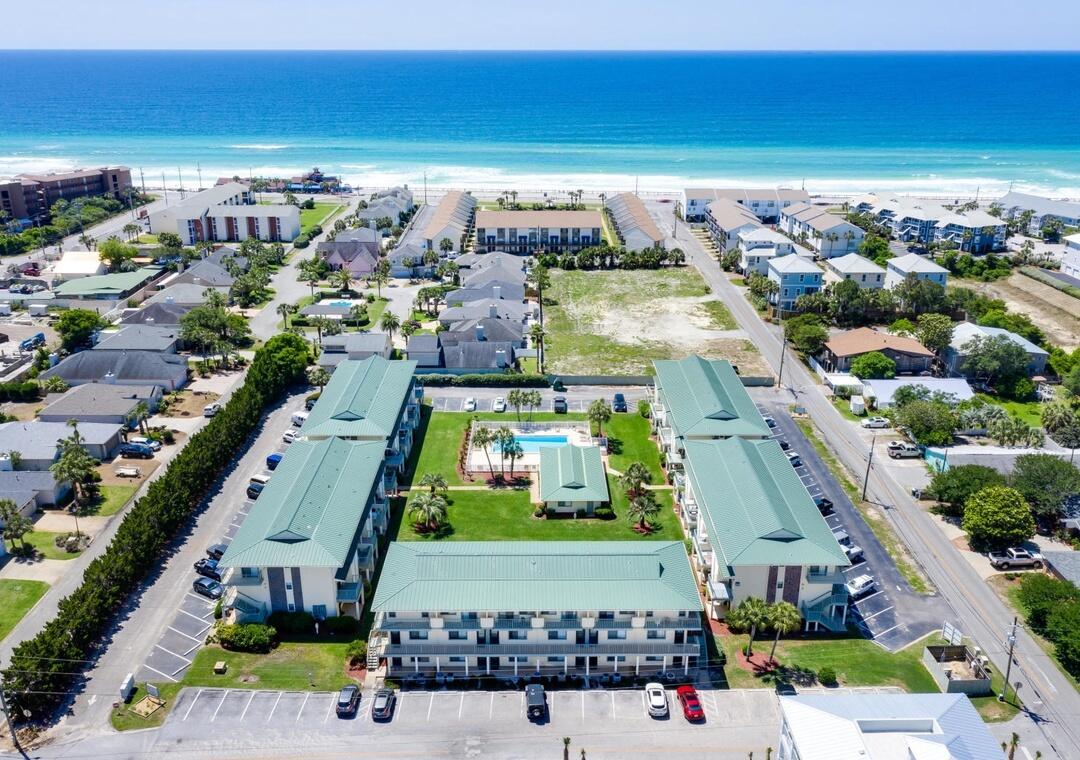 The WAIT is OVER! Step into effortless coastal luxury with this beautifully positioned ground-floor retreat in Sandprints, just moments from the sugar-white sands of Miramar Beach. Perfectly located only two blocks from the Gulf, this one-bedroom condo offers the rare combination of walkability, privacy, and stair-free convenience, with your designated parking space right outside your front door.

Inside, the open-concept layout is both inviting and functional, featuring tile flooring throughout and a spacious living area designed for comfort and relaxation. The kitchen offers ample space to gather, entertain, or prepare meals with ease, making it just as ideal for quiet nights in as it is for hosting after a day at the beach. Read more... The generously sized bedroom provides a peaceful escape with a queen bed and abundant storage, while the well-appointed bathroom offers dual access from both the hall and bedroom for added convenience. A full-sized washer and dryer are tucked neatly away, enhancing the unit's livability for both owners and guests.

Step out back to your private covered patio, where lush green space and tranquil surroundings create the perfect setting for morning coffee or evening unwinding. Enjoy easy access to the gated community pool and grilling area, ideal for laid-back coastal gatherings.

Meticulously maintained and rental-ready, this residence delivers strong appeal as both a personal getaway and investment opportunity. Just a short stroll to local favorites like Pompano Joe's, and minutes from premier golf, watersports, Destin Commons, and Silver Sands Outlets--this is coastal living at its most convenient and compelling.