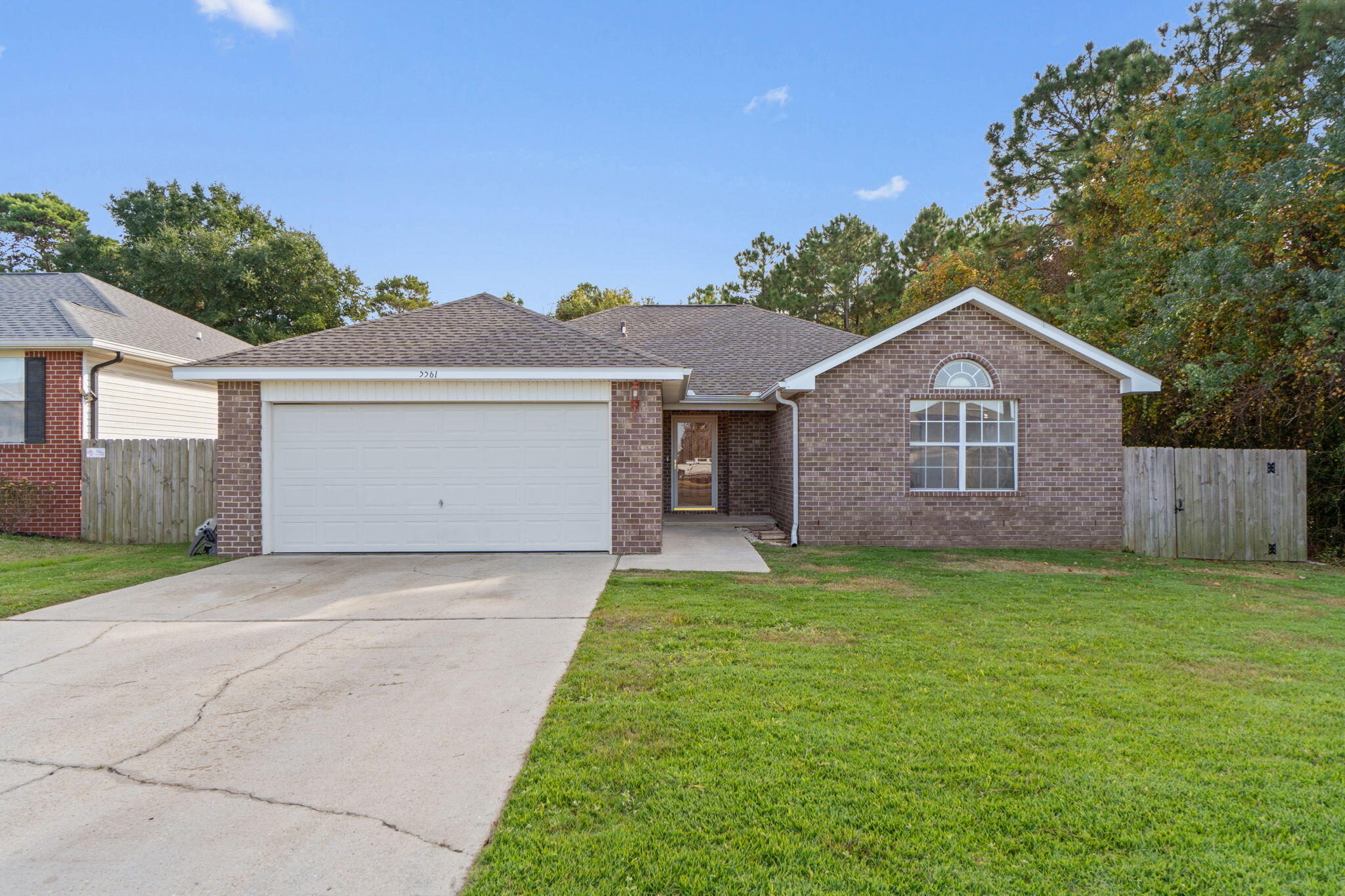 Located in a welcoming sidewalk neighborhood in Gulf Breeze, this 3-bedroom, 2-bath brick home offers comfort, privacy, and convenience all in one. The open layout features cathedral ceilings in the great room, creating a bright and airy feel that flows easily into the dining and kitchen areas -- perfect for everyday living and gathering with friends.

The spacious primary suite includes a tray ceiling, walk-in closet, double vanity, garden tub, and separate shower. Step outside to enjoy added privacy with wooded views behind the home and no neighbor to the right -- a rare find.

You'll appreciate the solid-surface flooring throughout -- no carpet anywhere -- offering a clean, low-maintenance environment with no staining concerns and fewer allergy triggers. The home is move-in ready as it sits, with the primary opportunity to personalize being a countertop change to stone or quartz in the kitchen and bathrooms -- that simple update would instantly upgrade the space.