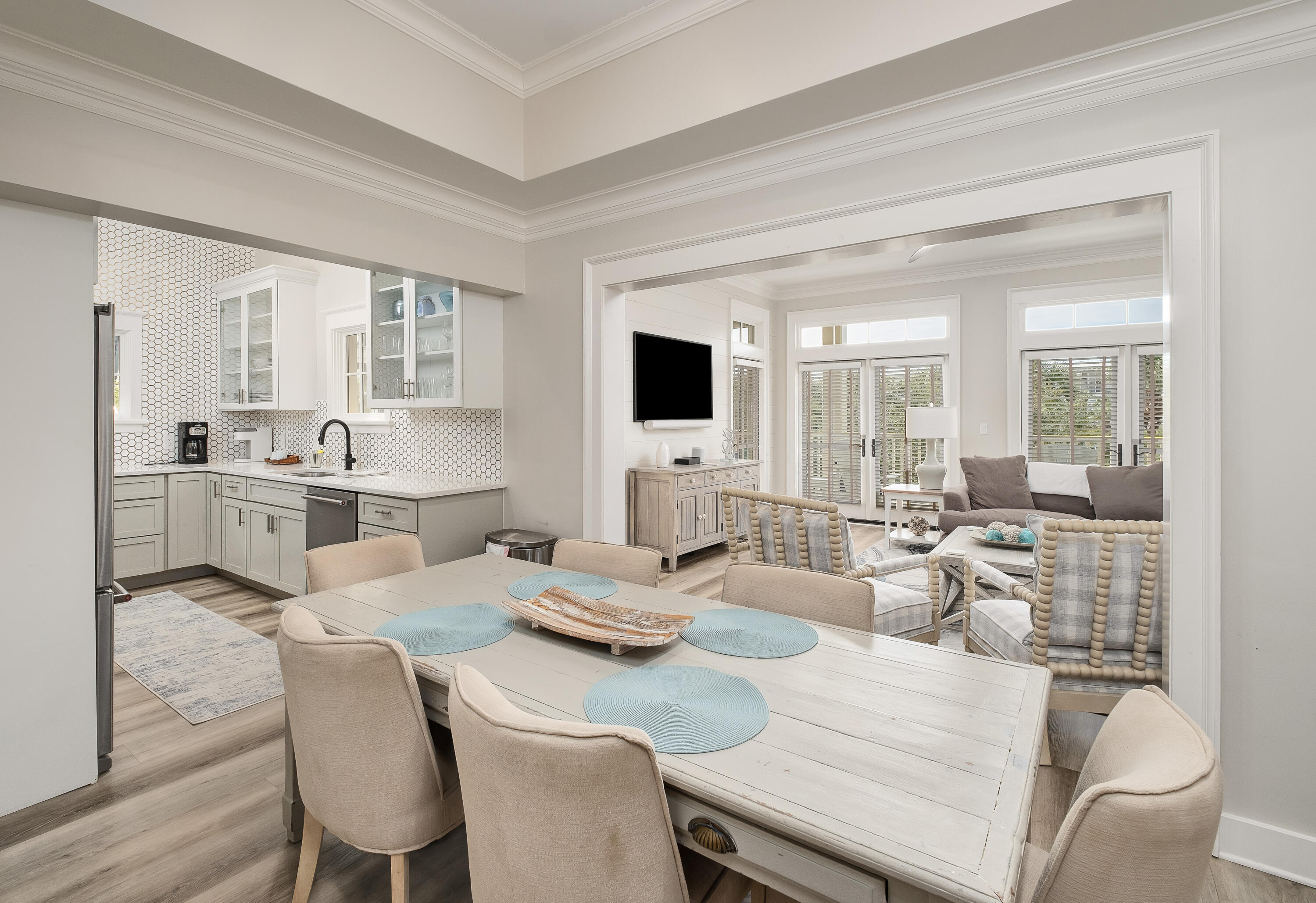Set within the vibrant Town Center district of WaterColor and overlooking scenic 30A, this beautifully renovated 2-bedroom, 2-bath condominium with a dedicated bunk room offers an exceptional blend of sophisticated coastal living and unmatched convenience. Ideally located just moments from the acclaimed WaterColor Beach Club, the boathouse on Western Lake, Cerulean Park, and an array of boutique shops and restaurants, the residence presents an outstanding opportunity for both personal enjoyment and investment potential. Thoughtfully redesigned with a refined coastal aesthetic, the interiors feature extensive upgrades throughout, including custom wall detailing, updated flooring, designer cabinetry, stone countertops, statement lighting, premium plumbing fixtures, and a fully refreshed furnishing and décor package. Positioned on a single level within the second floor of the building, the residence is easily accessible via elevator or staircase and offers a comfortable, open-concept layout designed for effortless entertaining.

Natural light fills the spacious living and dining areas, which extend seamlessly onto an expansive wraparound porch as an inviting outdoor retreat ideal for dining, lounging, or enjoying the coastal atmosphere after a day on the beach. The primary suite offers generous proportions and a private ensuite bath, while the guest accommodations include an additional bedroom, a charming bunk space, and a large secondary bath complete with laundry area. The beautifully updated kitchen combines functionality with elevated design, creating a space equally suited for casual mornings or hosting guests.