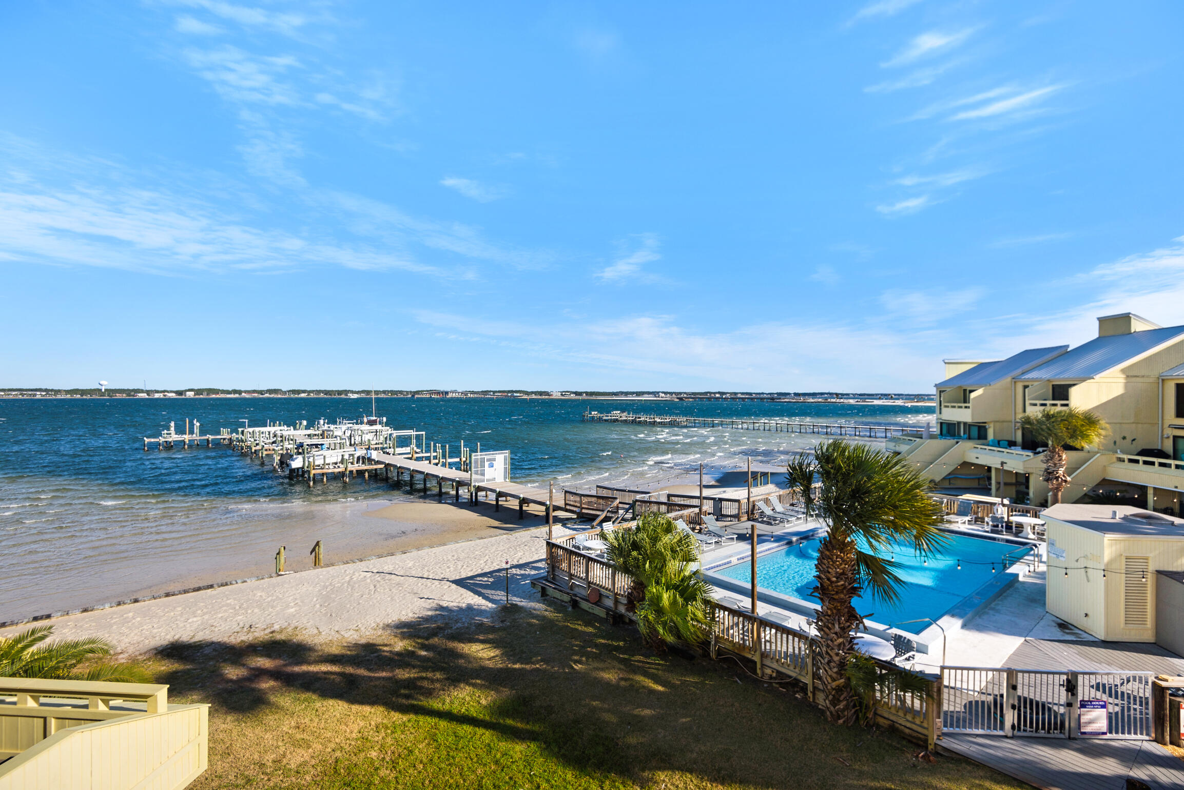 Experience the ultimate coastal lifestyle in this stunning 2,467 sq ft bayfront oasis at Buena Vida on Navarre Beach. Perfectly positioned to capture breathtaking water views from nearly every window, this beautifully designed 4-bedroom, 3-bath retreat offers the rare combination of luxury, comfort, and outdoor adventure. Wake up each morning overlooking your personal boat slip with lift and spend your days enjoying everything this outdoorsman's paradise has to offer -- from boating and fishing to watching dolphins and sea life right from your balcony. Natural light pours throughout the spacious multi-level floorplan, creating a bright and airy atmosphere that perfectly complements the tranquil bayfront setting. This is one of the few units in the complex featuring the highly desirable fourth bedroom and third full bathroom addition, making it ideal for large families, guests, or maximizing vacation rental income potential.

Relax poolside while overlooking the sparkling waters of the bay, enjoy a match on the tennis courts, or take a short stroll to the sugar-white sands of Navarre Beach and the iconic Navarre Beach Pier. The oversized garage provides ample storage for beach gear, fishing equipment, and personal belongings.

Currently operating as a successful vacation rental, this property offers excellent income-producing potential for investors or the perfect opportunity for a second home getaway. Additional features include two AC units for maximum comfort and energy efficiency, with the west building location helping keep utility costs lower year-round.

Whether you are searching for a primary residence, vacation retreat, or high-performing investment property, this exceptional bayfront gem truly checks every box. Don't miss your opportunity to own one of Navarre Beach's most unique and desirable properties to bring your boat!