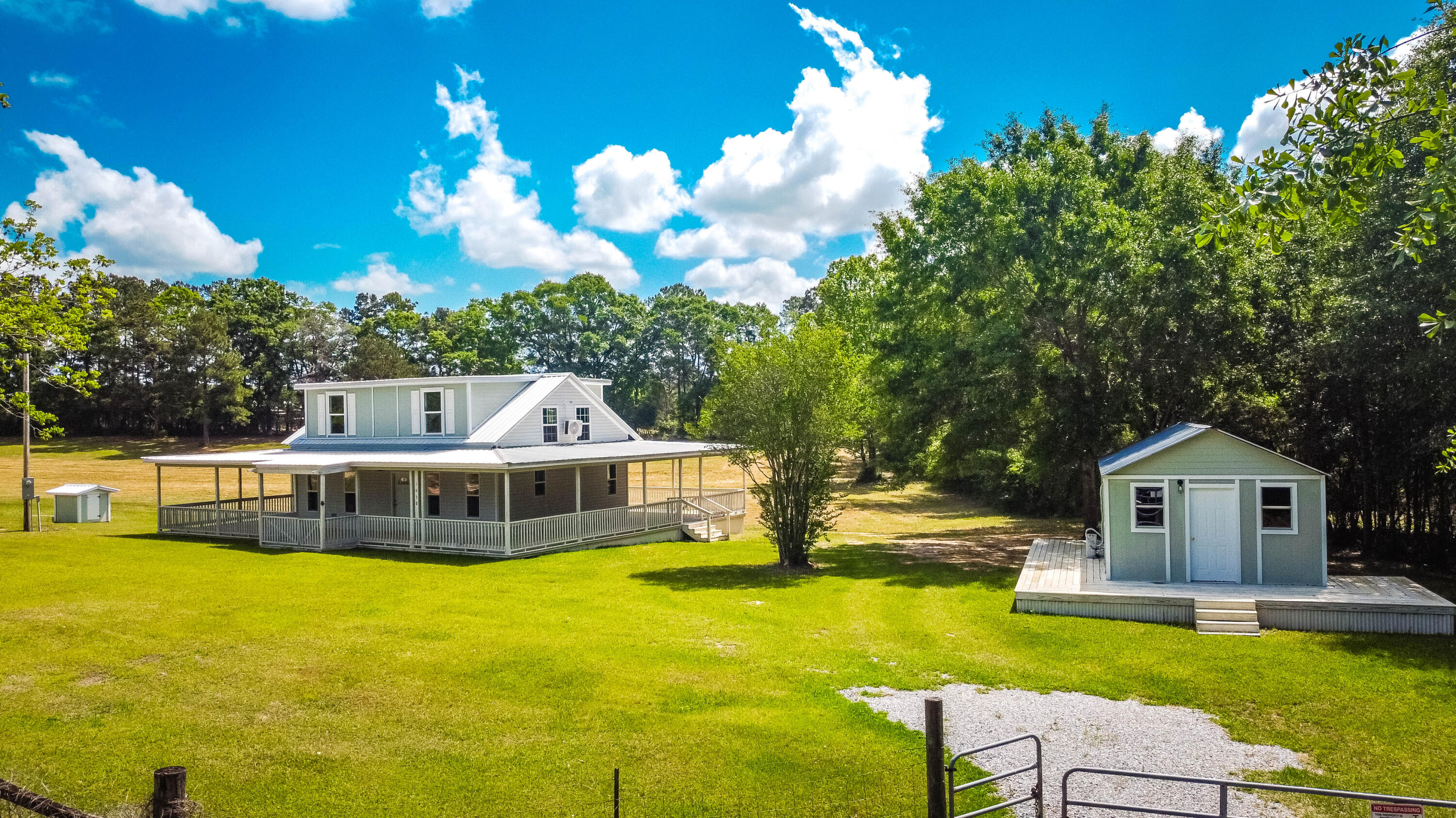 Tucked away on a quiet country road, this charming 2-bedroom, 2-bath home offers the perfect blend of privacy, functionality, and convenience. Situated on 5.5 beautiful acres, this property is ideal for those seeking horse property or simply wanting room to roam, garden, or enjoy the outdoors. A finished shed provides valuable additional space--ideal for a home office, studio, workshop, or guest overflow. Enjoy peaceful country living while still being just minutes from a quaint small town with local shops, dining, and community charm and a large natural lake. Plus, the stunning Emerald Coast beaches are only an hour drive away, making it easy to enjoy the best of both country and coastal lifestyles. Roof, mini splits, installed in 2025. Termite bond. buyer to verify sq. footage