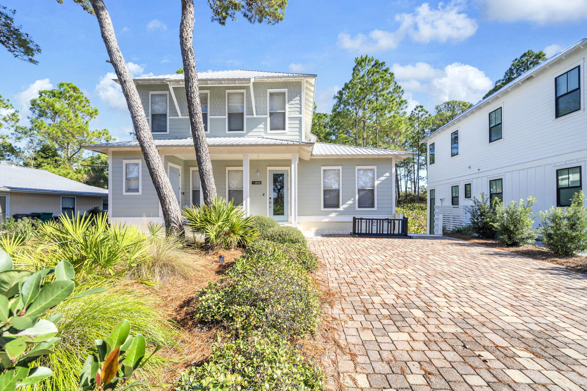 RENTAL READY & ROCKIN!! MOTIVATED SELLER! SELLER REMODEL/FLOORING ALLOWANCE!  This adorable little cottage-style home is already well-stocked and set up for comfort and fun at the beach! With beach access a short walk away, pool access right behind the home, and a canal for sporting activities right across the street, the location is perfect for outdoor activities of all sorts. Inside, the living space is wide open and bright with tons of seating! The kitchen is set up for home cooking and has tons of storage with the added space attached. The first-floor primary bedroom is expansive and is attached to a luxurious stone bathroom with a water closet and a huge shower. Upstairs, there are two queens in one bedroom and a king in another. The cute bunk room has a twin-over-full bed.  The upstairs bathroom is large and jack and jills with two other rooms. Outside a beautiful deck was installed to allow for more private enjoyment of the Florida sunshine. Come see why this needs to be your next rental!