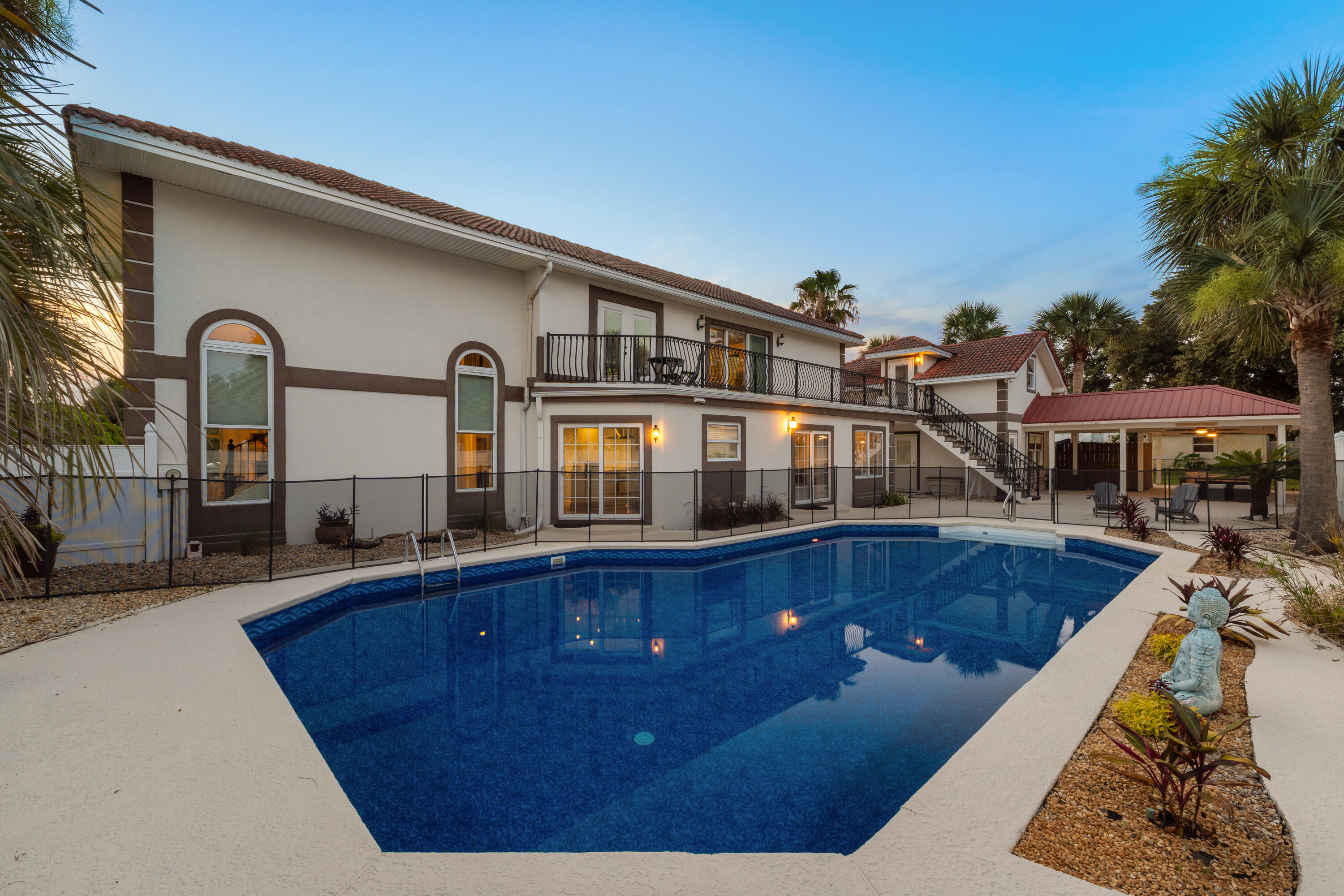 Experience the ultimate in coastal living with this stunning Mediterranean-style home offering breathtaking
Santa Rosa Sound views, 4 bedrooms, 3.5 bathrooms, 3,024 square feet of beautifully designed living space,
a resort-style 20' x 40' pool, and a private in-law suite. Perfectly situated just steps from the Santa Rosa
Sound, community dock, and beach access, this exceptional property blends luxury, comfort, and
convenience.
From the moment you enter, you'll be captivated by soaring ceilings, elegant tile flooring,
recessed lighting, and abundant natural light streaming through oversized architectural windows. The
spacious living room features dramatic vaulted ceilings, a cozy fireplace, and incredible water views,
creating the perfect setting for relaxing or entertaining.
The gourmet chef's kitchen is designed to impress with commercial-grade stainless steel appliances, a
professional gas range with vented hood, gorgeous quartz countertops, designer tile backsplash, custom
soft-close cabinetry, abundant storage, and a large center island ideal for gathering with family and friends.
The thoughtfully designed floor plan offers spacious bedrooms, generous living areas, and a fully equipped
in-law suite perfect for guests or multigenerational living. Step outside to your private backyard oasis
featuring an expansive pool, ample patio space, and tropical surroundings. Whether you're looking for a
primary residence or second home!