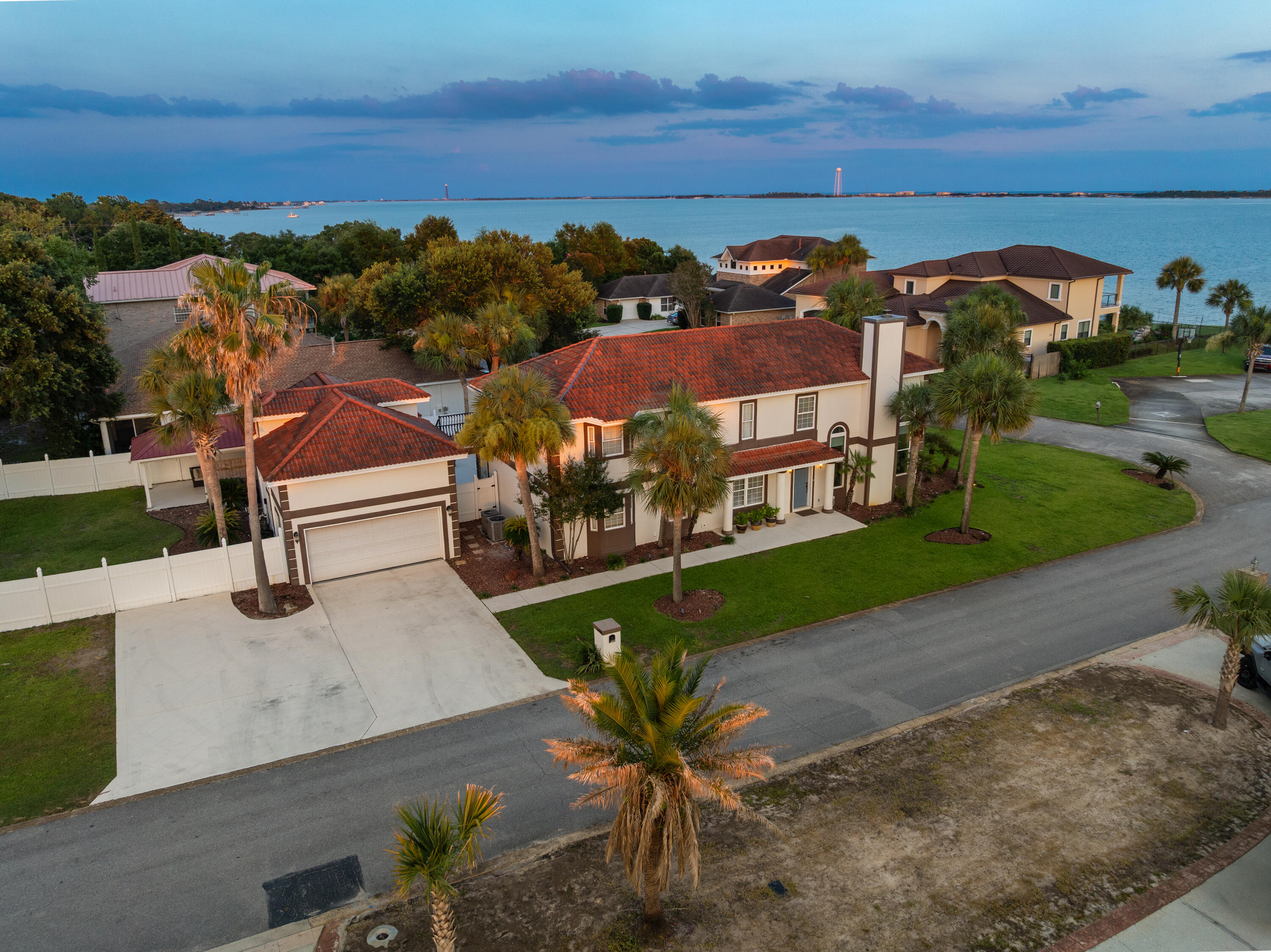 Experience the ultimate in coastal living with this stunning Mediterranean-style home offering breathtaking
Santa Rosa Sound views, 4 bedrooms, 3.5 bathrooms, 3,024 square feet of beautifully designed living space,
a resort-style 20' x 40' pool, and a private in-law suite. Perfectly situated just steps from the Santa Rosa
Sound, community dock, and beach access, this exceptional property blends luxury, comfort, and
convenience.
From the moment you enter, you'll be captivated by soaring ceilings, elegant tile flooring,
recessed lighting, and abundant natural light streaming through oversized architectural windows. The
spacious living room features dramatic vaulted ceilings, a cozy fireplace, and incredible water views,
creating the perfect setting for relaxing or entertaining.
The gourmet chef's kitchen is designed to impress with commercial-grade stainless steel appliances, a
professional gas range with vented hood, gorgeous quartz countertops, designer tile backsplash, custom
soft-close cabinetry, abundant storage, and a large center island ideal for gathering with family and friends.
The thoughtfully designed floor plan offers spacious bedrooms, generous living areas, and a fully equipped
in-law suite perfect for guests or multigenerational living. Step outside to your private backyard oasis
featuring an expansive pool, ample patio space, and tropical surroundings. Whether you're looking for a
primary residence, second home, or investment property, this exceptio