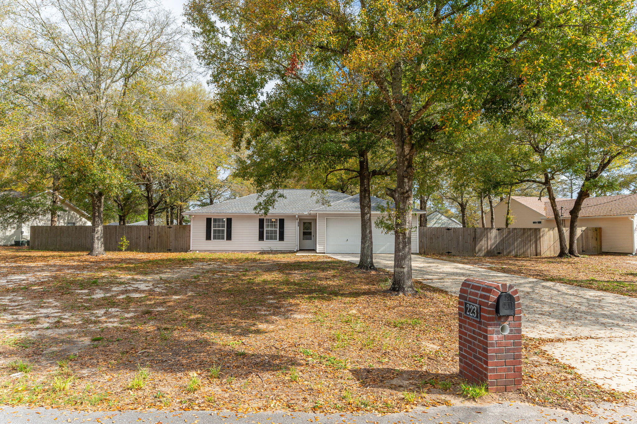 Well-maintained and affordable home located on a spacious .32-acre lot in a convenient Crestview location near shopping, dining, healthcare, and military bases. This home features a bright living room with cathedral ceilings and a corner fireplace, plus brand new carpet throughout. The primary bedroom offers a coffered ceiling and walk-in closet, and the kitchen includes ample cabinetry and new flooring with all major appliances, including washer and dryer.
Major updates include roof (2020), HVAC (2024), and water heater (2025). Enjoy a large, privacy-fenced backyard with plenty of space to relax or entertain