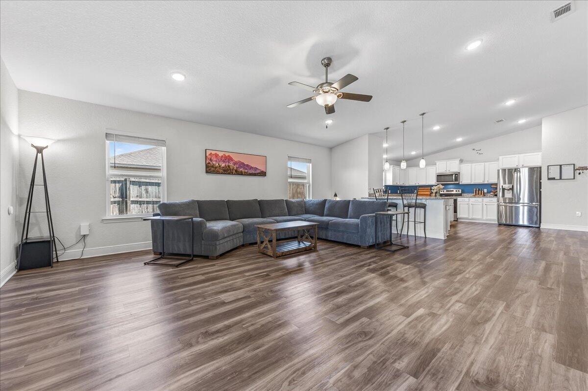 This 2020-built home in Heather's Place offers a spacious and functional layout in a central Gulf Breeze location! Inside, you'll find an expansive open floor plan designed for both everyday living and entertaining, along with brand new carpet in all four bedrooms. The kitchen offers abundant cabinetry, granite countertops, a large island, pantry, breakfast bar, and a nearby dining nook, providing plenty of space to gather and host. The living room is bright and inviting with recessed lighting, a vaulted ceiling, and direct access to the covered back porch! The split floor plan provides privacy, with the primary suite tucked away at the rear of the home. The bedroom includes access to the covered patio and a spacious en suite bathroom featuring double granite-topped vanities, a garden tub, a tiled walk-in shower, a private water closet, and dual oversized closets. Three additional bedrooms are located at the front of the home and share a full bathroom with a tub/shower combo. Outside, enjoy a fully fenced backyard with a storage shed and a covered porch perfect for relaxing. The home also includes a two-car garage, a grinder pump (2023), and a sodded front and back yard, adding to its curb appeal and functionality. VA Assumable loan available! Located just 8.5 miles from Navarre Beach and a short drive to major Northwest Florida military bases, this home is conveniently located and ready for its next family!
