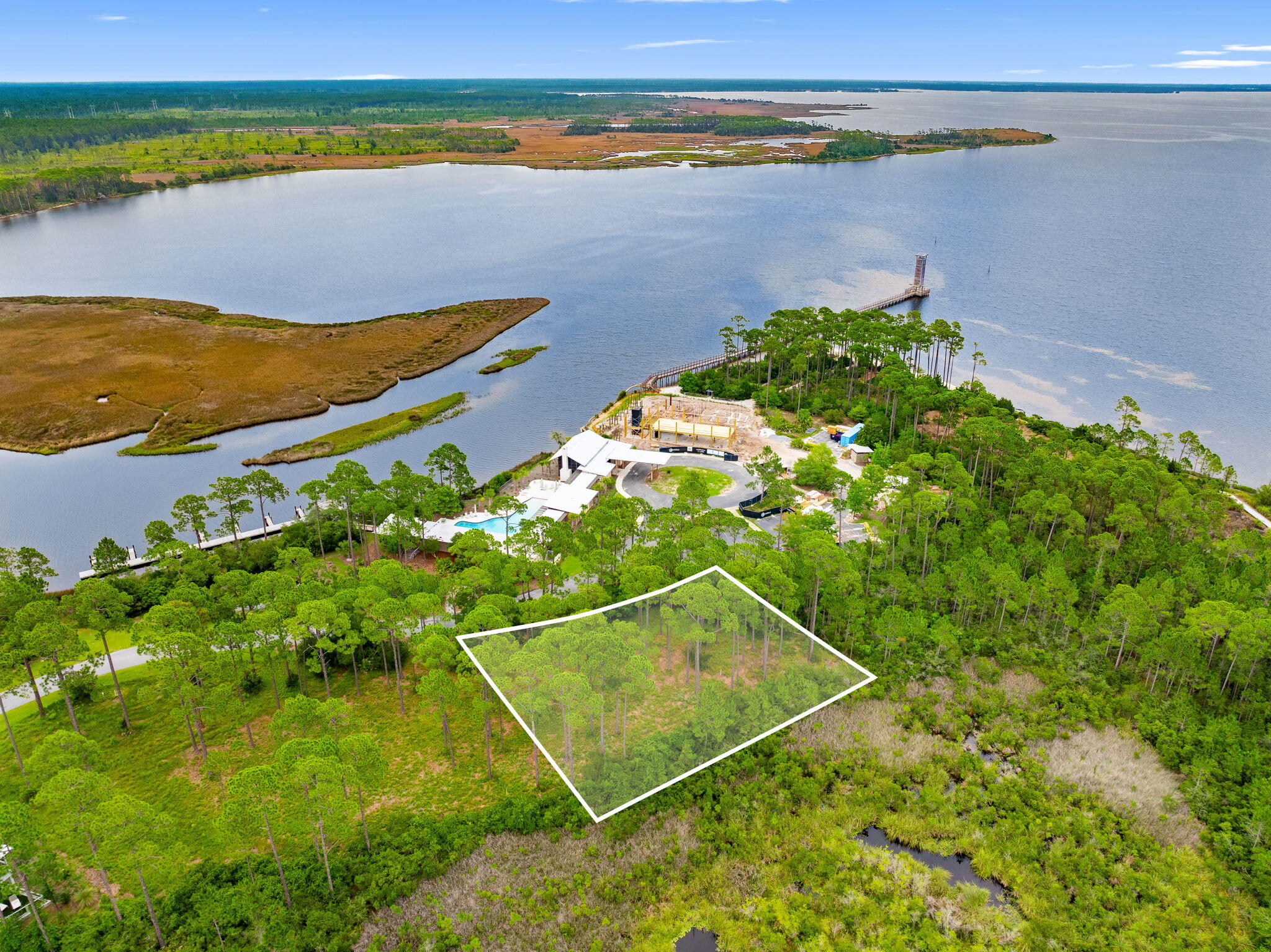 Beautiful Bay View lot located within the gated RiverCamps community. RiverCamps is an exclusive waterfront community. This nature oasis is surrounded by three stunning bodies of water and lush pine forest. While this community feels like a secluded retreat it is still only approximately 10 minutes away from the beach! This lot is the closest lot to the newly built pool, the boat day docks, the fitness center currently under construction, and the future River House. You will be within 
 Just a few steps of these luxury amenities! Amenities also include access to West Bay and Crooked Creek, boat launch, Camp ground, boardwalks and trails, and kayak and paddle boards. RiverCamps is in close proximity to many local business's. It is only 10 miles from Pier Park and the famous white sandy beaches. It is also 2 and a half miles from NW Florida Beaches International Airport. 3 and a half miles from Publix, to be opening soon. And approximately 5 miles to new hospital, to be opening in 2028. All information is deemed reliable, but not guaranteed. Buyer to verify if important.