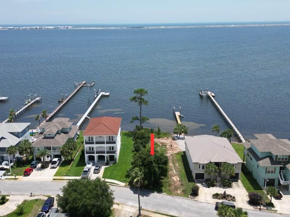 This is your opportunity to own the last available waterfront lot in the highly sought-after Sound Hammock Subdivision! This beautiful 0.23-acre waterfront homesite offers stunning sound views and is partially cleared, making it ready for your dream coastal home. The property features a seawall with rip rap already in place to help protect the shoreline, along with public underground utilities, providing an excellent foundation for your future build. The lot is zoned R-1A for single-family residential construction. According to the GIS map, no wetlands are shown on the property (buyer should verify independently, as GIS mapping is not a guarantee). An added advantage is the property's Ortega Sand (0-5% slopes) soil type, which is not classified as hydric soil, a favorable characteristic when evaluating wetland potential. As a resident of Sound Hammock, you'll enjoy exceptional community amenities, including: Community pier overlooking the sound, Private beach access, Kayak launch, Scenic nature trail, and a Community pool.  Building setbacks for this lot are: Front: 25 feet Sides: 6.5 feet Rear: 50 feet from the Mean High Water Line. Whether you're planning a primary residence, vacation getaway, or investment property, this rare waterfront homesite offers the perfect blend of natural beauty, community amenities, and coastal living. With very few waterfront opportunities remaining, this is the last waterfront lot available in Sound Hammock. The seller is highly motivated and welcomes offers. Don't miss your chance to secure one of the area's most desirable waterfront homesites.
