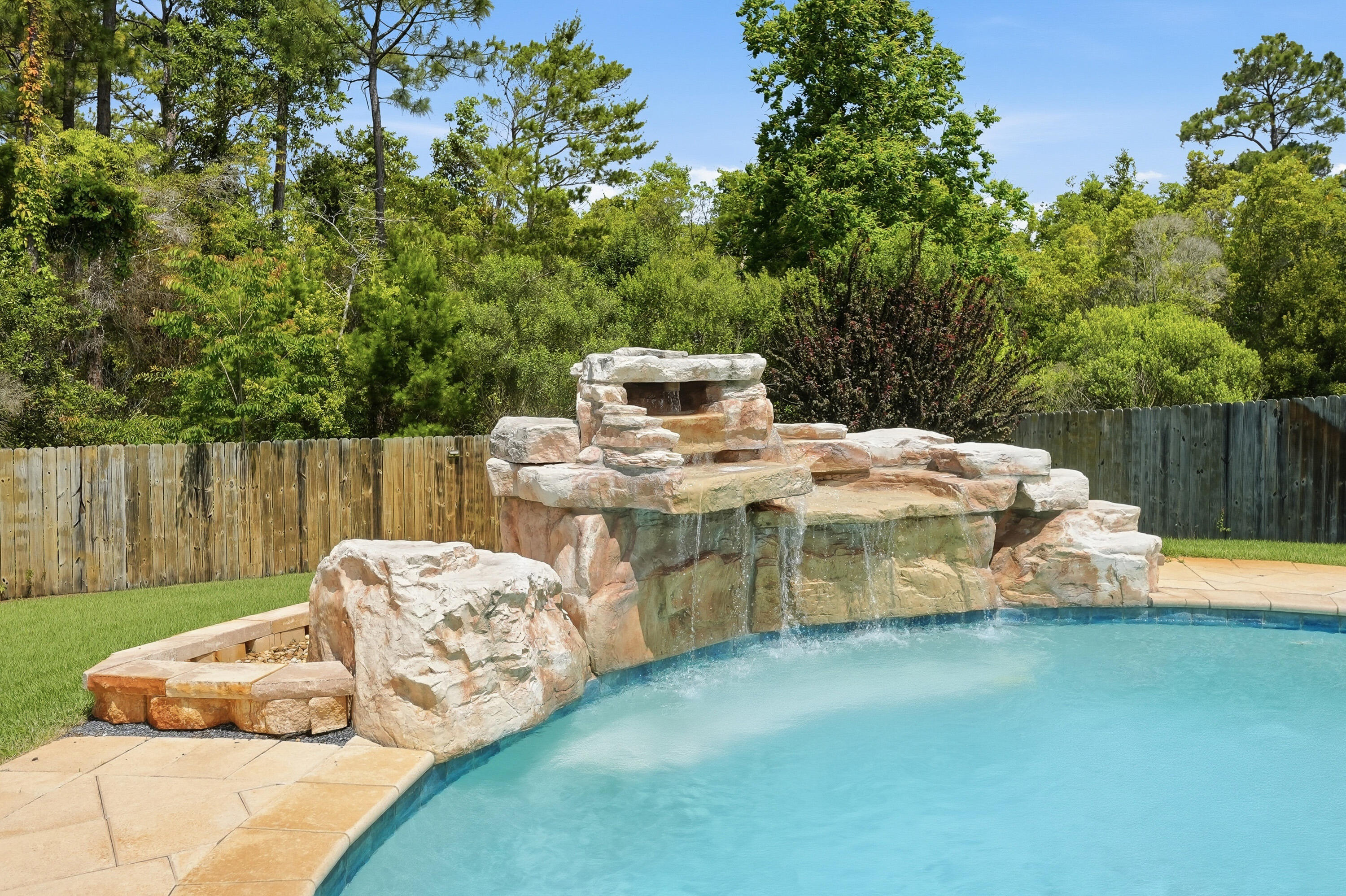 Experience the perfect blend of comfort, style, and outdoor living in this beautifully updated, 4-bedroom, 2.5 bathroom, brick home located in Treasure Isle Estates. This home is located only MINUTES to the emerald colored water and white sand of Navarre beach, public boat launch access, restaurants, shopping and so much more. Designed with a desirable split and open concept floor plan, this home showcases soaring double tray ceilings, crown molding, luxury plank flooring throughout, and abundant natural light from oversized windows overlooking the backyard retreat. 

The spacious living area centers around an inviting electric fireplace, while the roomy kitchen features a large island, granite counter tops, backsplash, custom built pantry with pull out drawers and baskets, and a convenient spice rack mounted on the pantry door.

The owner's suite offers a luxurious custom walk-in closet with adjustable shelving, providing exceptional organization and storage. The owner's suite bath features a double vanity, a large garden tub perfect for relaxing after a long day, and a standalone tile shower, convenient for those days on-the-go.  

Step outside to your private backyard oasis for a swim to cool off on those hot summer days.  Enjoy a stunning Gunite saltwater pool with a fountain, controlled directly from the Pentair app, along with a newly installed screened entertainment room (2025) all connected to the covered patio. Complete with a wall-mounted TV, ample seating areas, a fire pit, and solar-powered motion activated lighting for added convenience, the outdoor space is ideal for relaxing or hosting family and friends. The fully fenced backyard also includes a storage shed for all of those outdoor tools, toys, and pool accessories. 

Additional features include a covered front porch, decorative front water feature, video doorbell system, extreme weather window coverings, dedicated laundry room, and a 2-car garage equipped with ceiling-mounted storage shelving. Significant upgrades include a Culligan water softener and reverse osmosis system installed in 2023, a transferable termite bond established in 2023,  a Nest programmable thermostat, and fresh interior paint completed in 2024. Underground utilities add to the clean curb appeal and convenience of this exceptional property.

From the thoughtful custom storage solutions to the resort style outdoor amenities, this move-in-ready home offers everything you need for comfortable everyday living and effortless entertaining.

Don't wait. This is home!

Buyer(s) is responsible for verifying ALL data and information, including lot size and room measurements, as it is deemed to be reliable but not guaranteed.